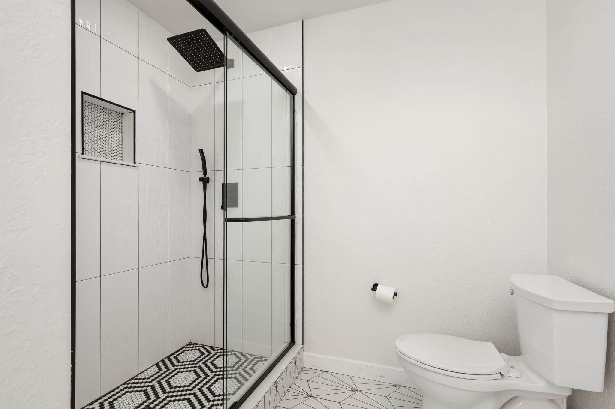 BR8 Spa-Inspired Shower with Elegant Tile Work — Ultimate Comfort | Coastline Haven, Outer Banks