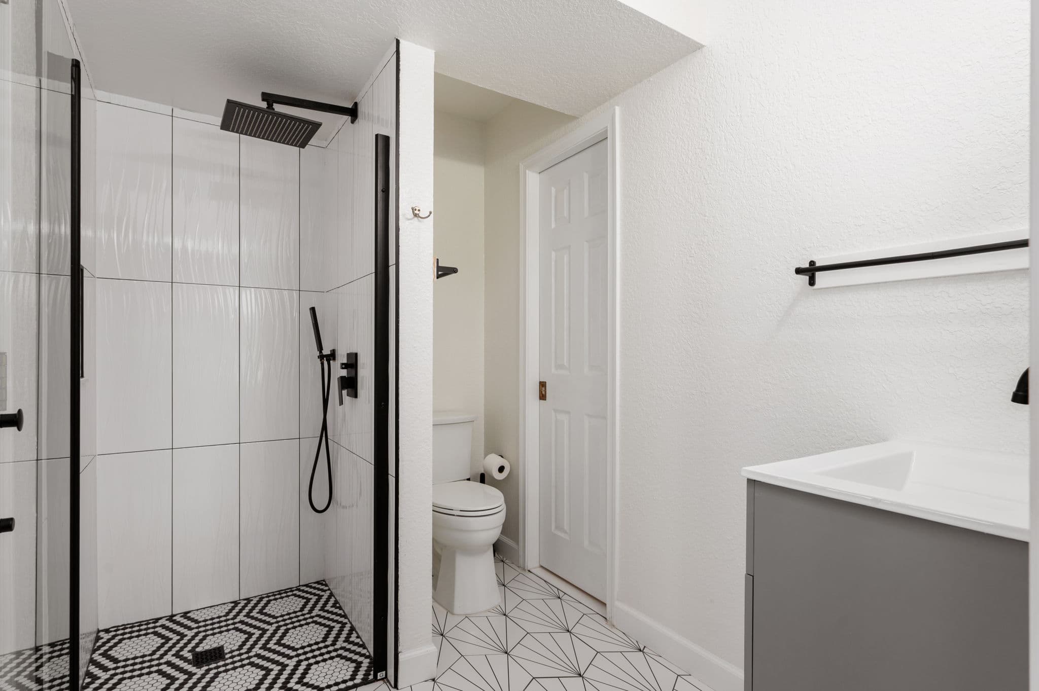 Main Floor Bathroom — Walk-In Shower with Rainfall Head & Modern Tile | Coastline Haven, OBX