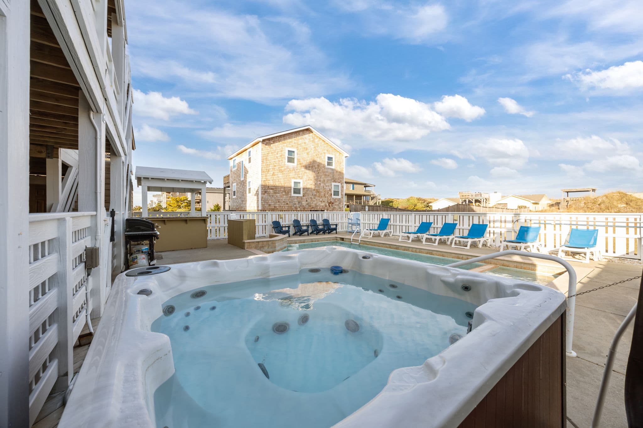 8-Person Hot Tub Flowing into the Heated Pool — Relax Under the Stars at Angler's Retreat Oceanfront Estate | Outer Banks