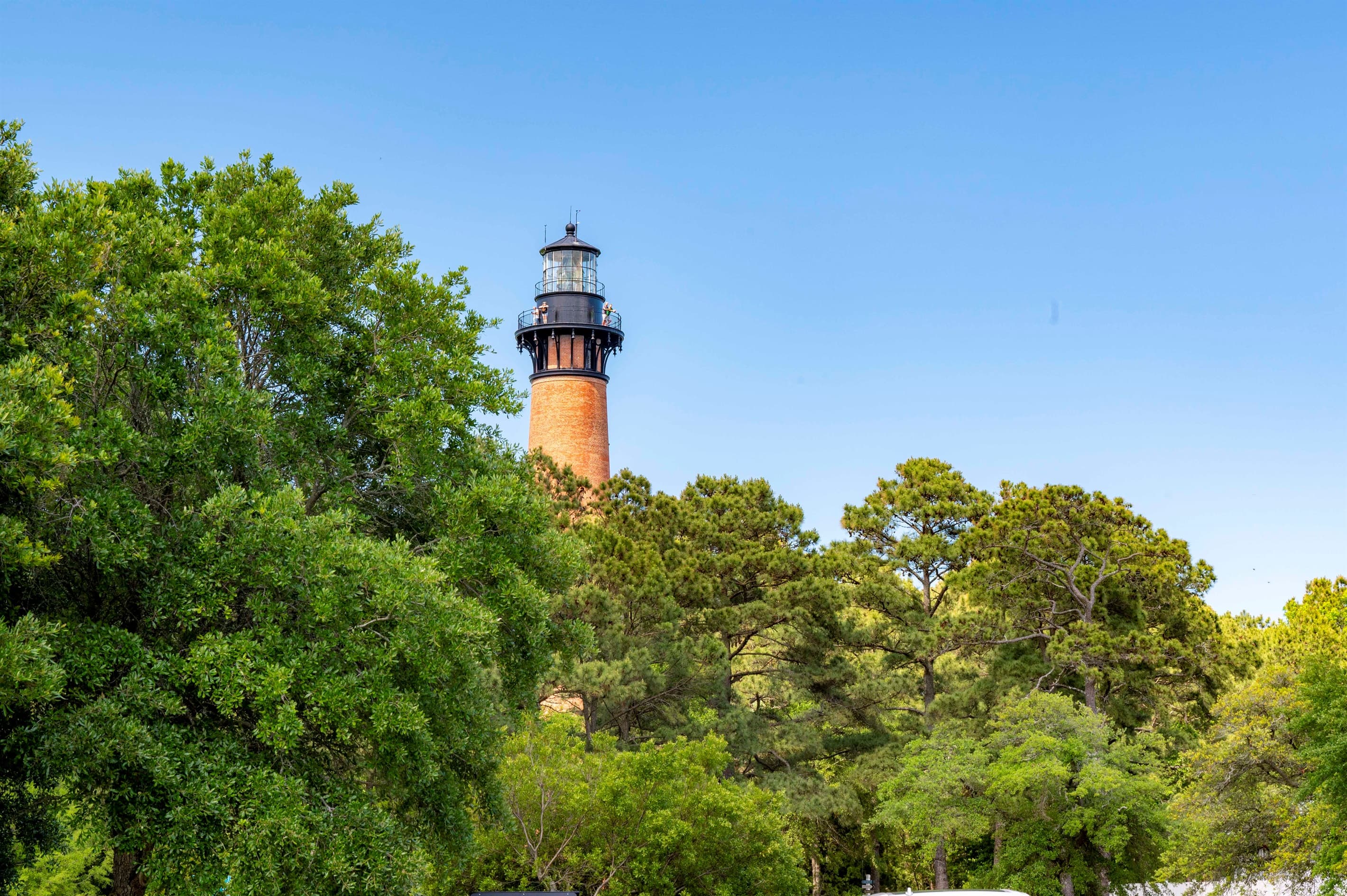 Corolla Lighthouse surrounded by maritime forest — explore local heritage and panoramic views during your luxury stay