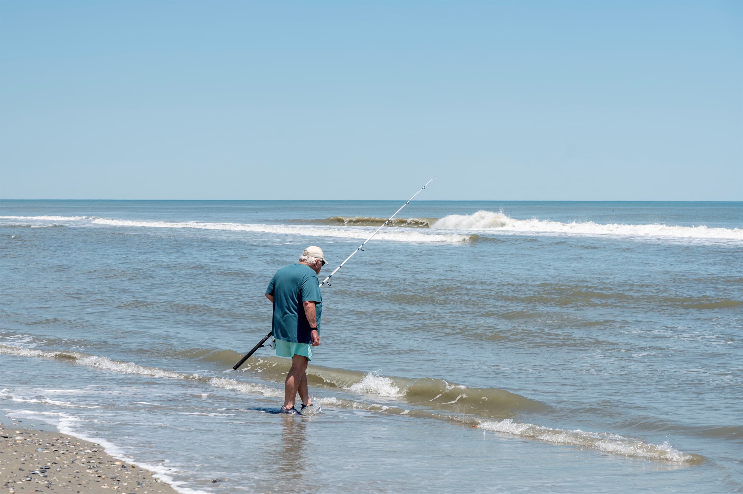 Stand-up paddleboarding on calm waters — water sports and coastal recreation elevate your Outer Banks experience
