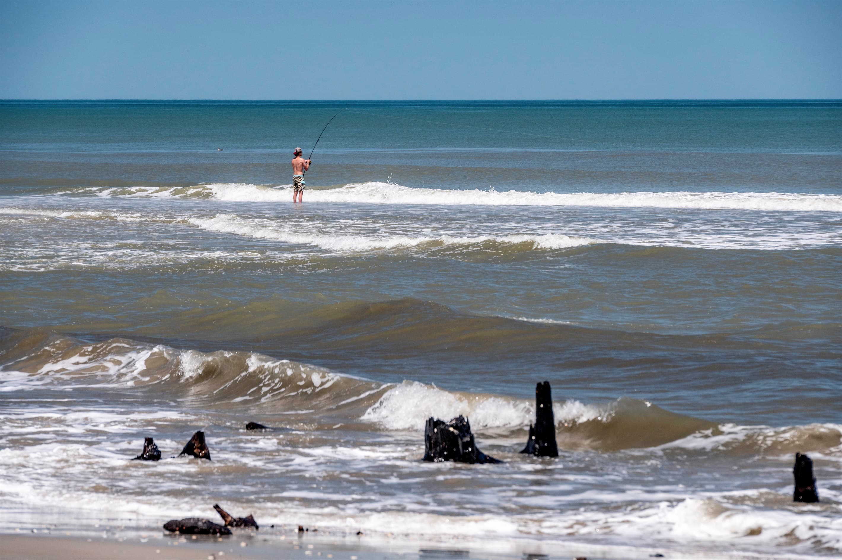 Outer Banks beachfront community — neighboring estates and pristine shoreline define this exclusive coastal enclave