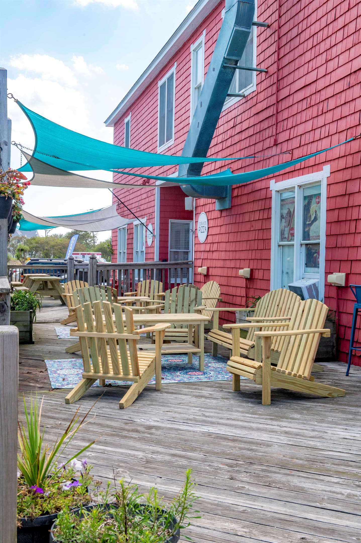 Scenic Adirondack chairs overlooking coastal greenery — relaxation opportunities throughout the Outer Banks community