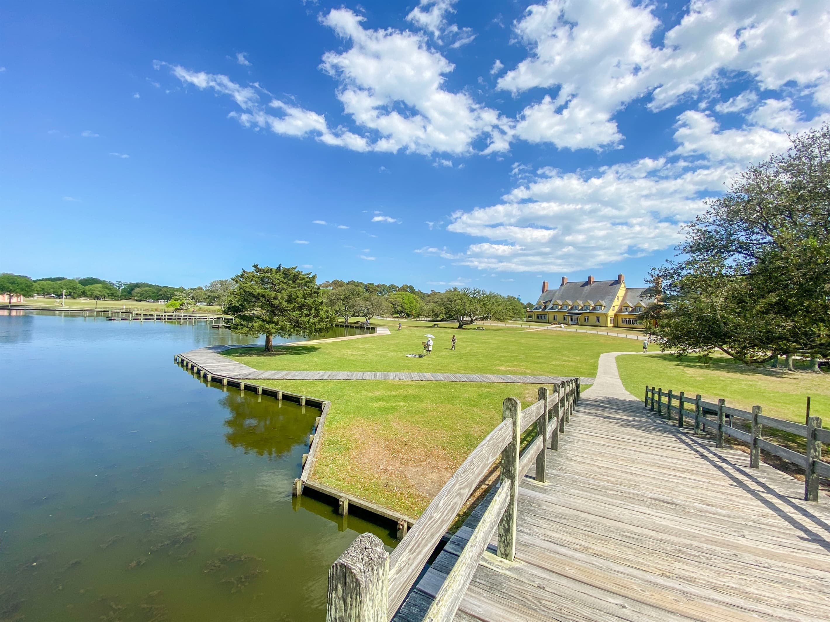 Tranquil pond and dock in the Corolla community — nature walks and peaceful waterside moments complement your retreat