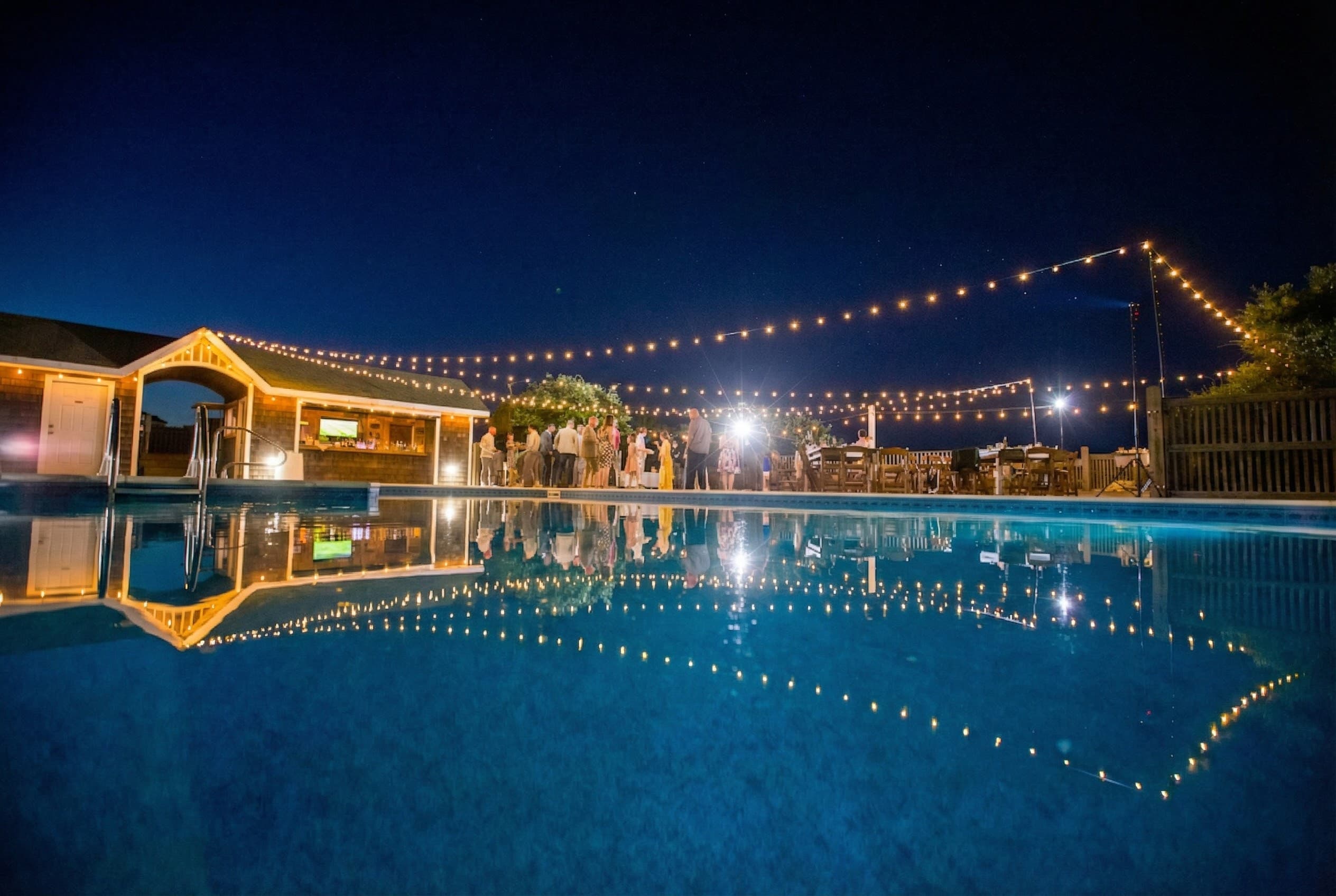 Magical Nighttime Poolside Gathering with Festive String Lights — Private Pool Deck for Celebrations & Events | The Mark Twain, Outer Banks