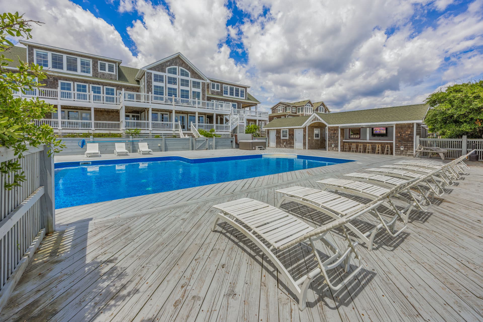Expansive Multi-Level Deck at Dusk — Wrap-Around Ocean Views, Outdoor Seating & Beach Boardwalk | The Mark Twain Estate, Outer Banks