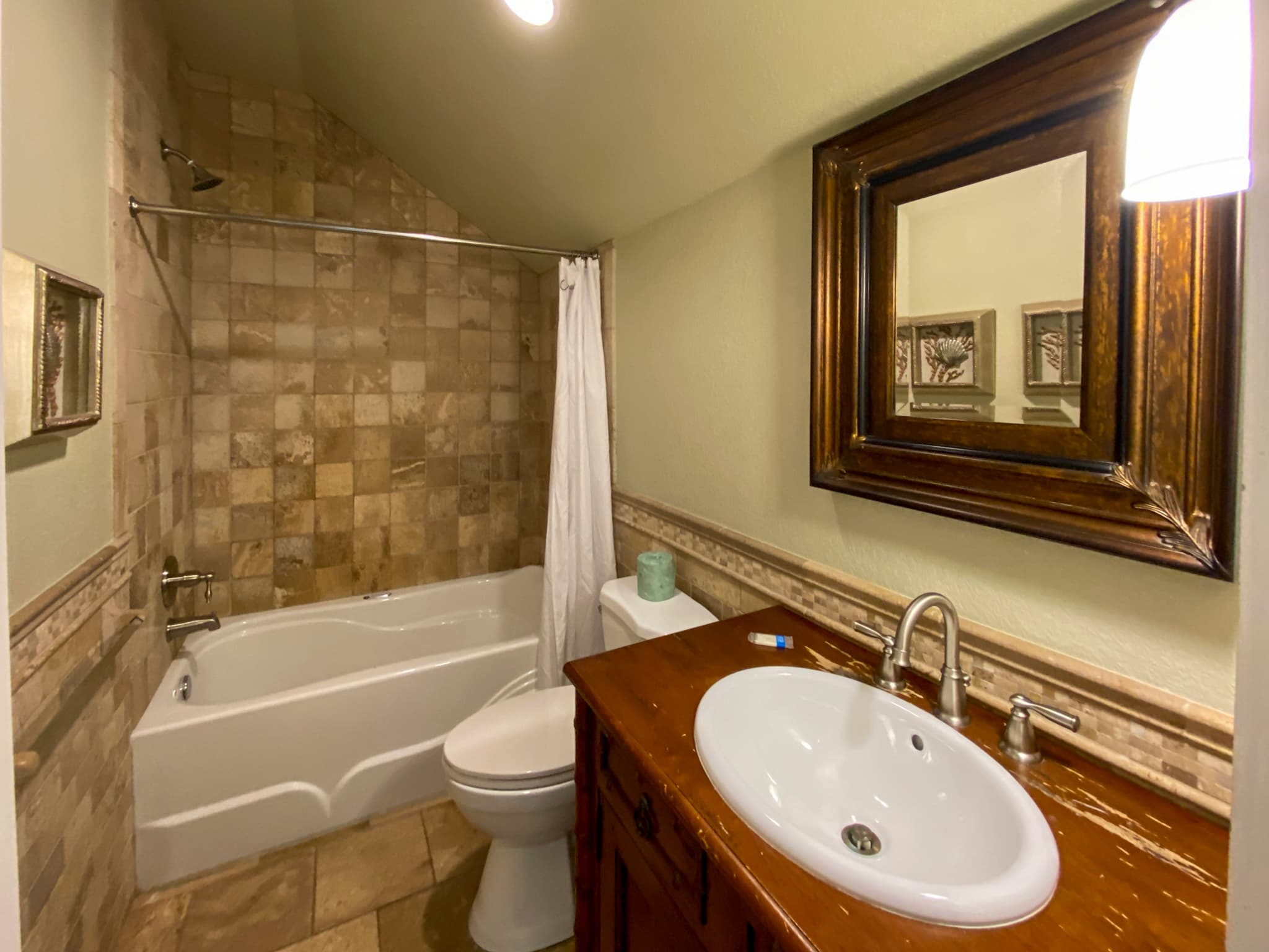 Spa-Inspired Stone Bathroom with Walk-In Shower & Natural Stone Finishes | The Mark Twain's Luxury Bathrooms, Outer Banks