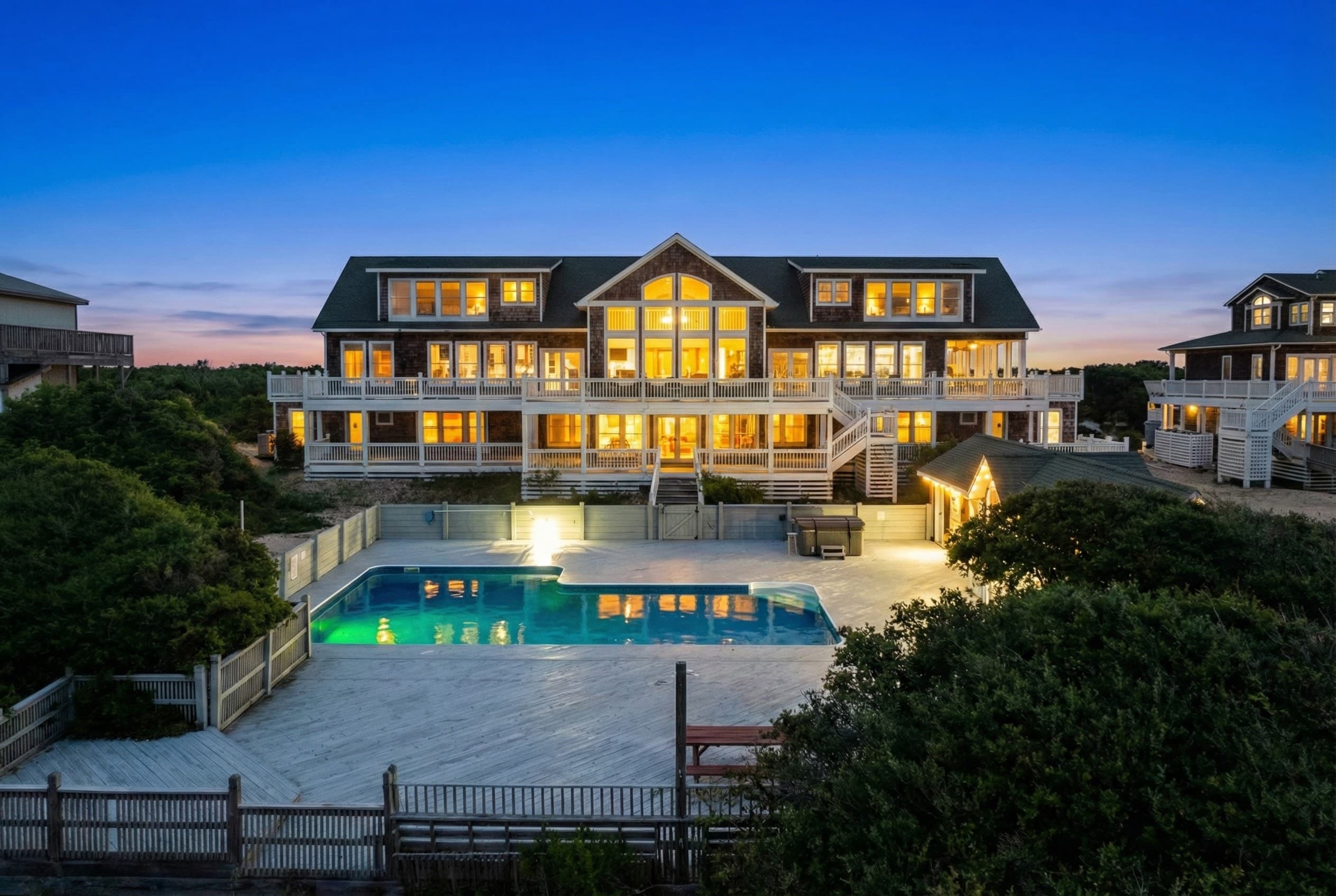 Illuminated Luxury Oceanfront Estate at Twilight with Private Pool — The Mark Twain's Stunning Architecture | 18-Bedroom Rental, Outer Banks