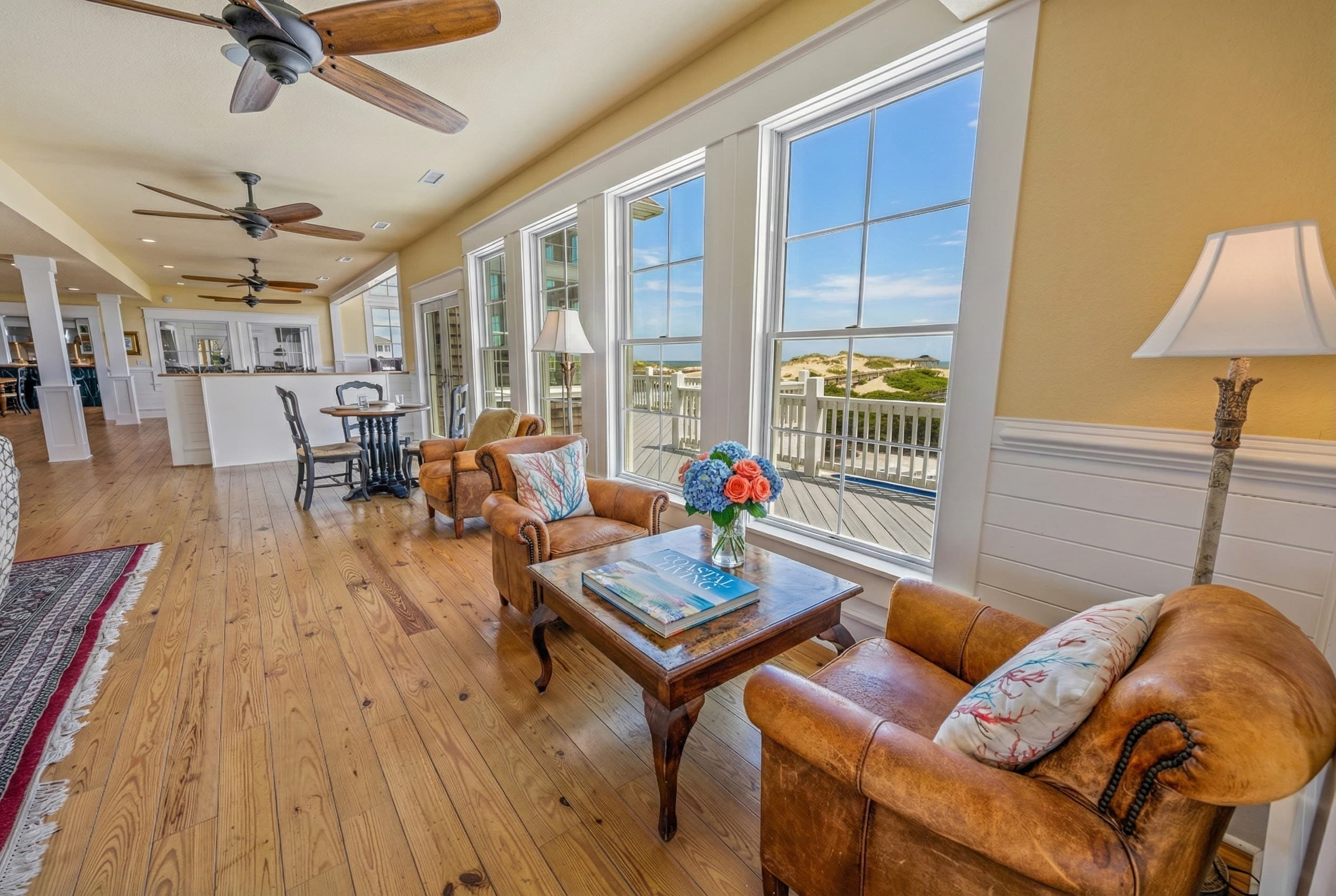Sun-Drenched Living Area with Panoramic Ocean Views & Warm Wood Floors — Coastal Luxury Design | The Mark Twain Oceanfront, Outer Banks