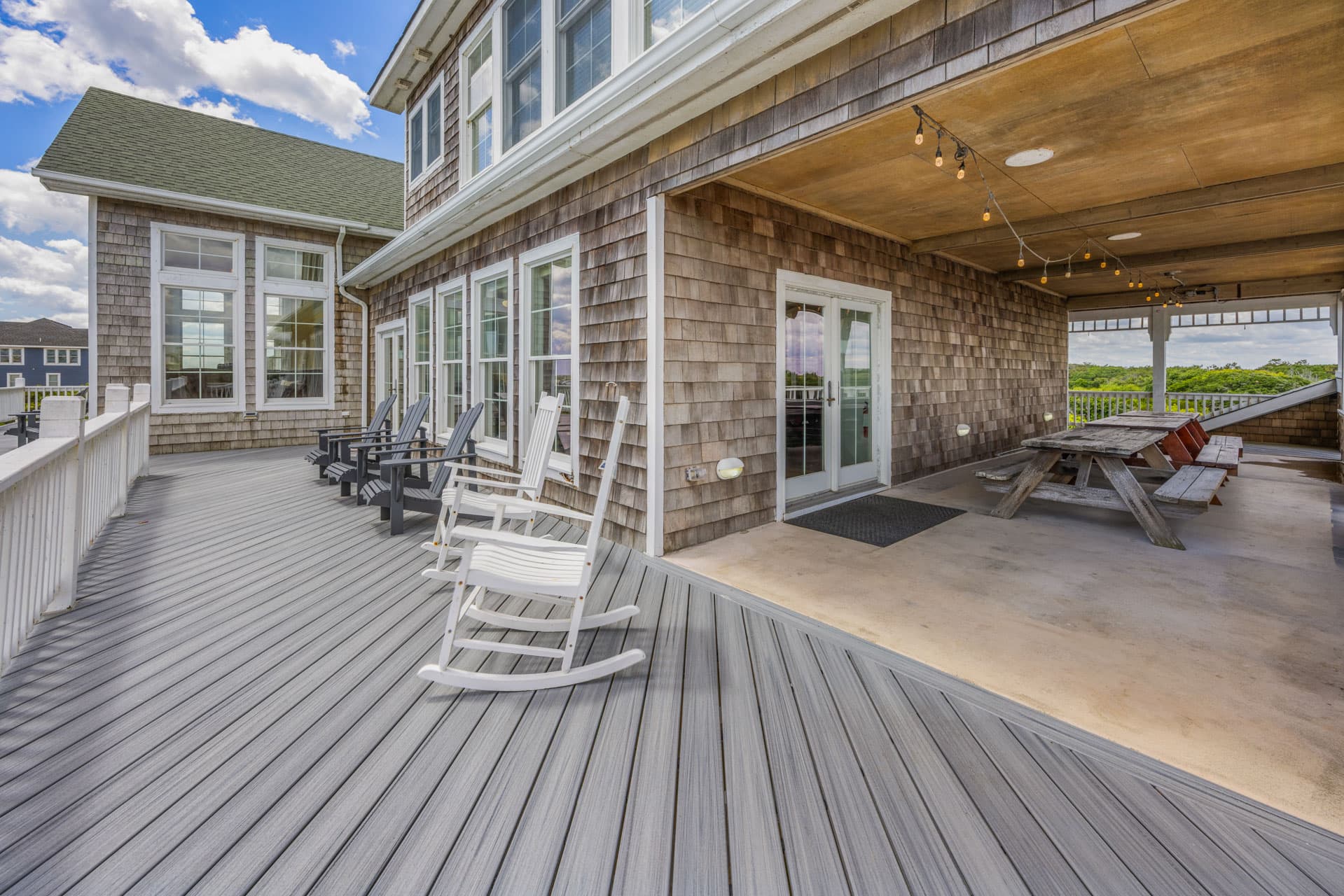 Covered Outdoor Deck with Comfortable Seating — Protected Ocean Views for All Weather | The Mark Twain Luxury Beach House, Outer Banks
