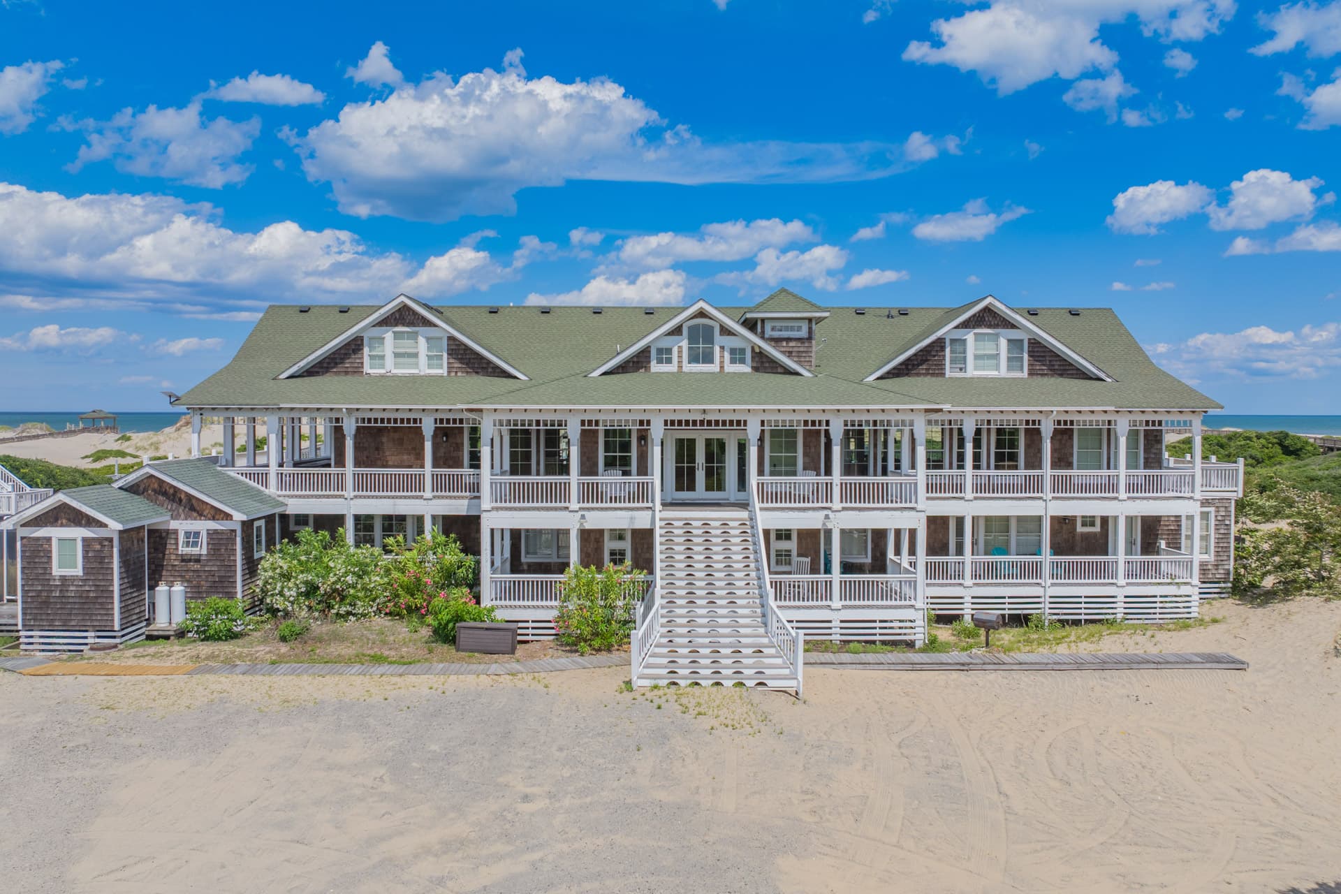 The Mark Twain Estate from the Beach — Grand Oceanfront Architecture Nestled Among Natural Dunes | 18-Bedroom Luxury Rental, Outer Banks