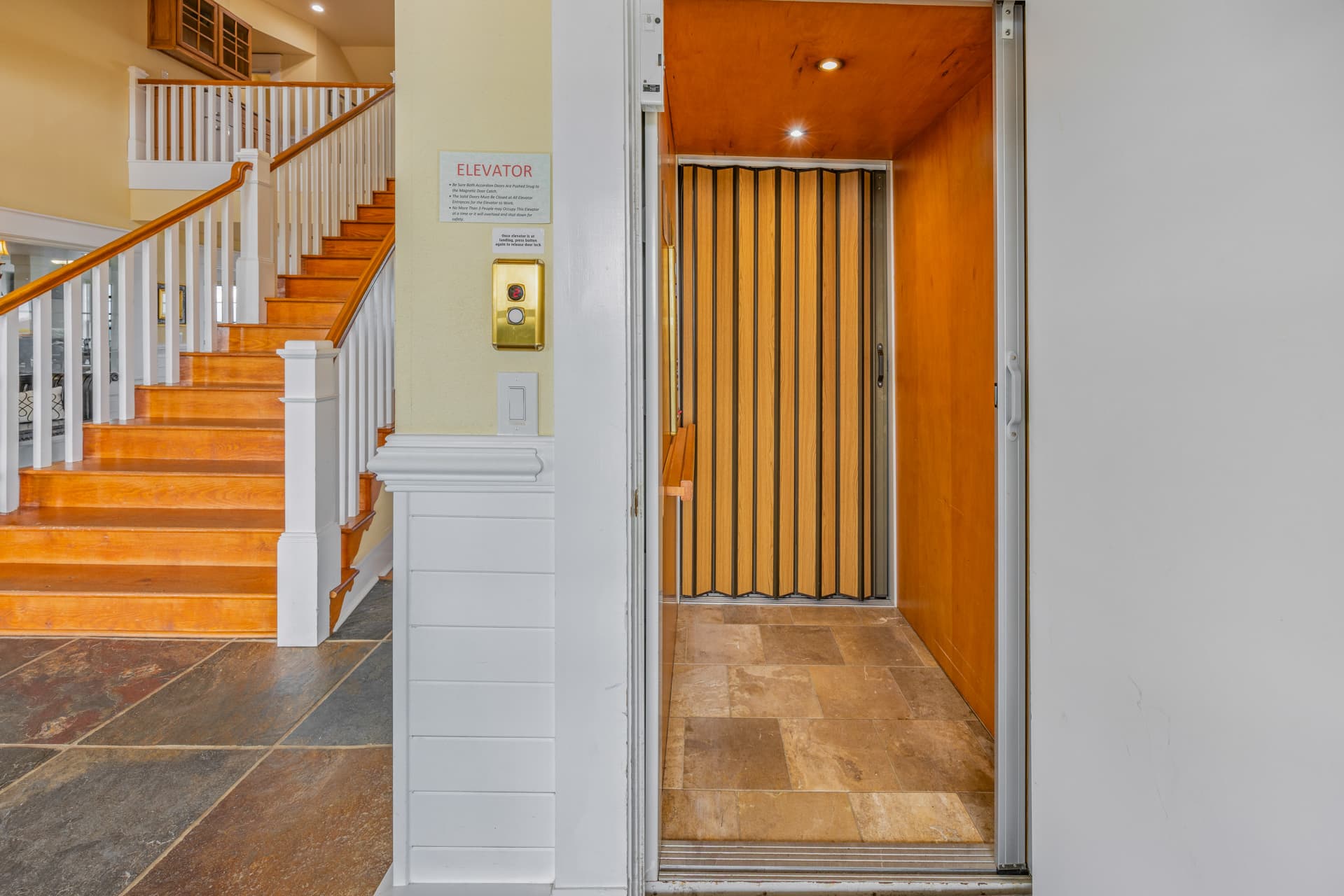 Illuminated Interior Staircase with Warm Wood Tones — Elegant Design Throughout | The Mark Twain 18-Bedroom Oceanfront Estate, Outer Banks