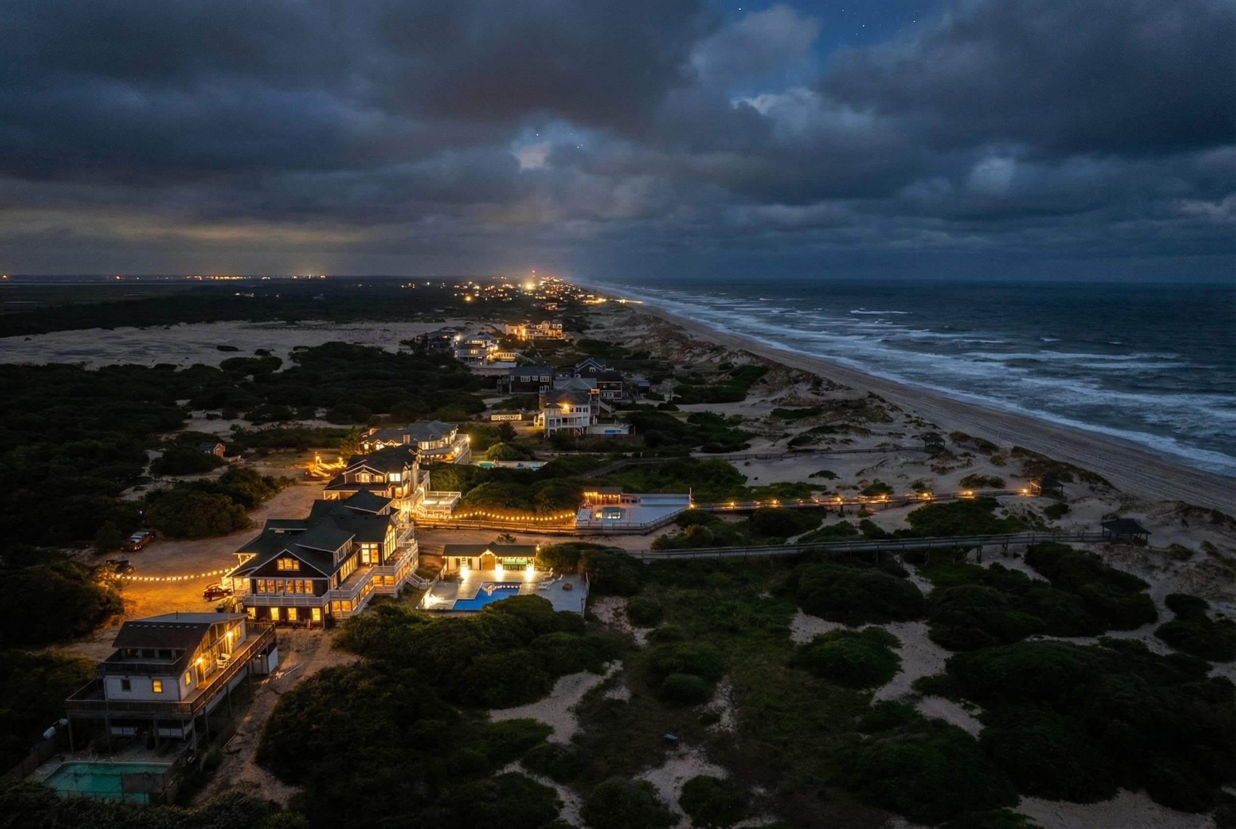Private Estate — Nighttime Aerial of Three Authors, Three Illuminated Oceanfront Homes | Corolla, OBX