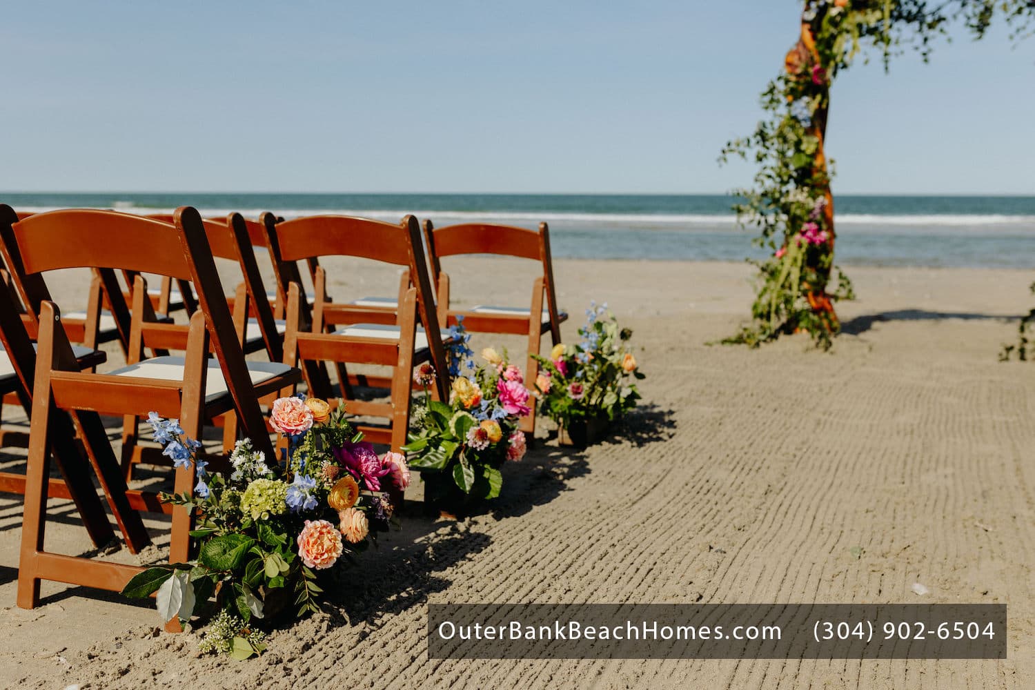 Ceremony Space — Intimate Wedding Setup with Floral Details & Ocean Backdrop | Three Authors, OBX