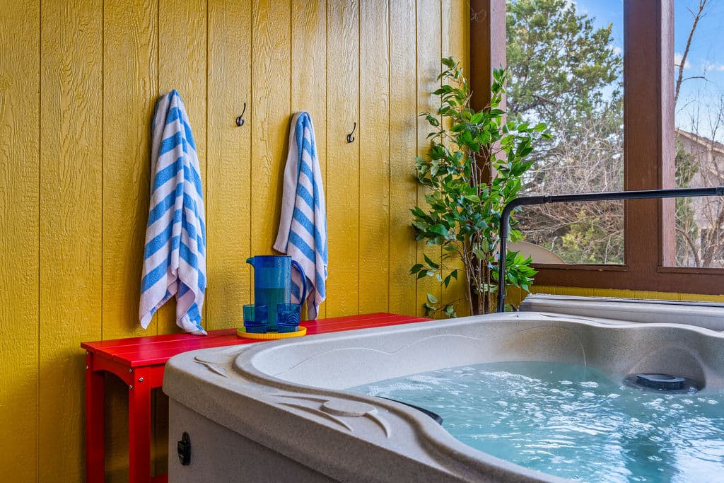 Unwind in the bubbling hot tub with a glass of wine — your private year-round oasis
