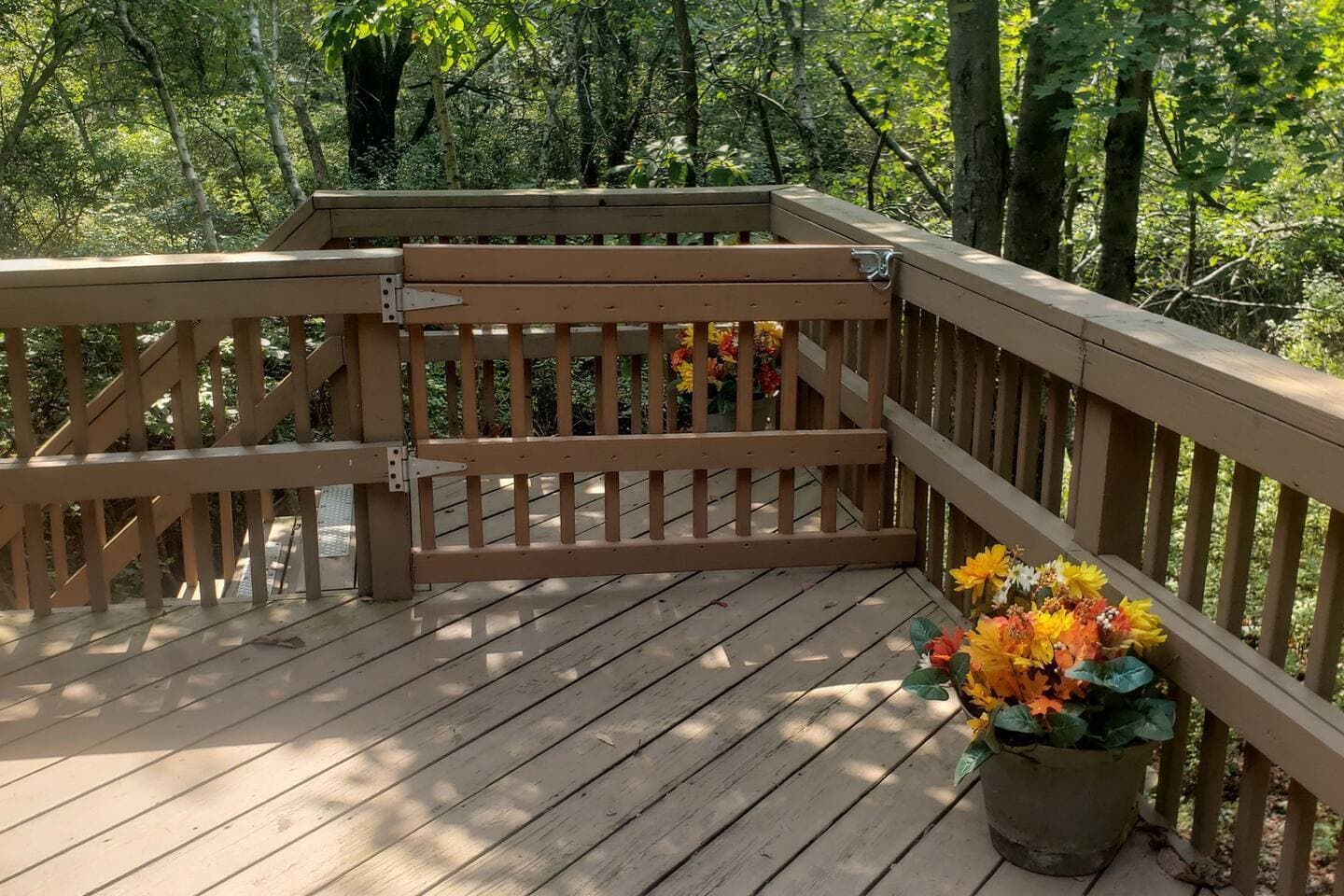 Safety gate on the deck added to help keep children from falling down the stairs and pets from running away. Safety is our main concern so we installed a gate!