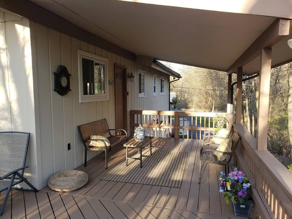 Covered deck perfect for sitting outside during a relaxing rainstorm.