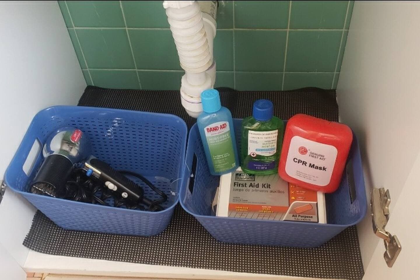 Under the sink in the bathroom we keep it fully stocked with a first aid kit, CPR device, and aloe gel in case you get sunburnt. 
