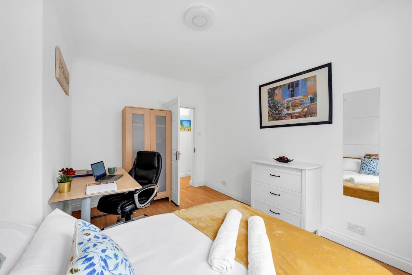The bedroom is beautifully decorated with a stunning art piece and equipped with heating, ensuring a cozy and comfortable night's sleep.