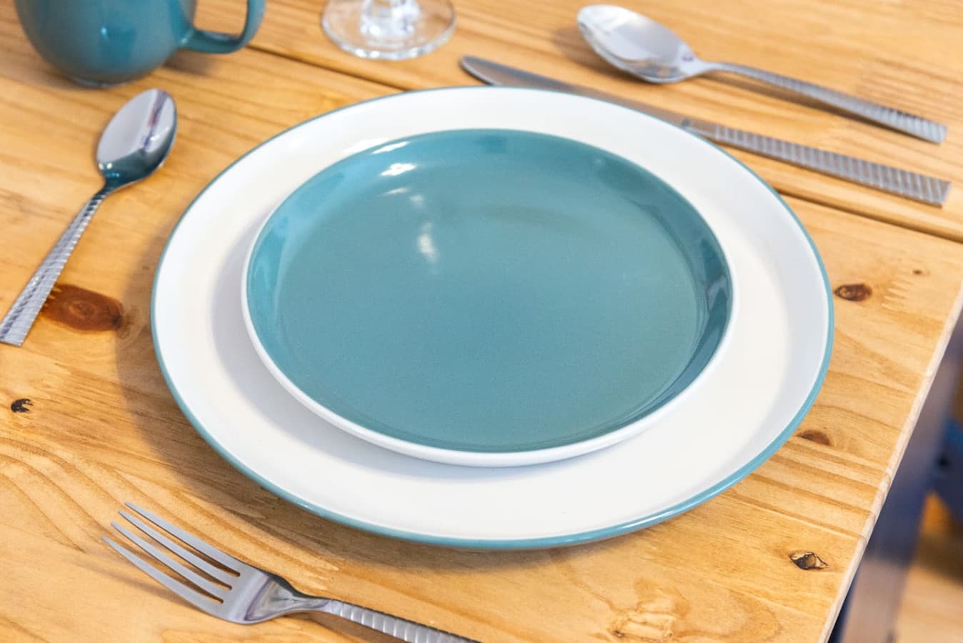 The dining area and beautiful cutlery offer an inviting space for enjoying meals with family and friends.