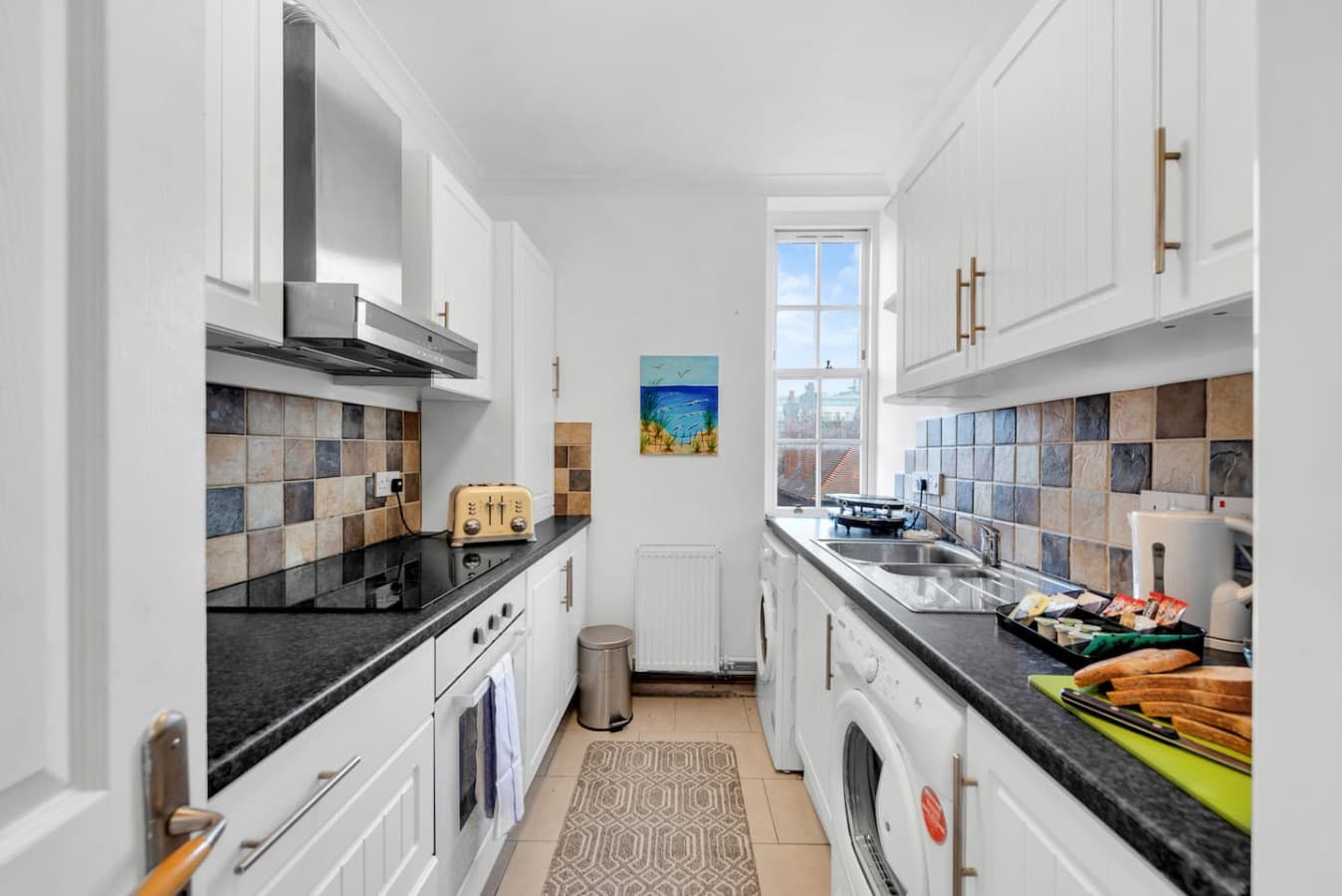 The well-equipped family kitchen is the heart of the home, complete with modern appliances (such as air fryer, oven, electric hob, fridge, dishwasher and washing machine), ample counter space, and plenty of storage.