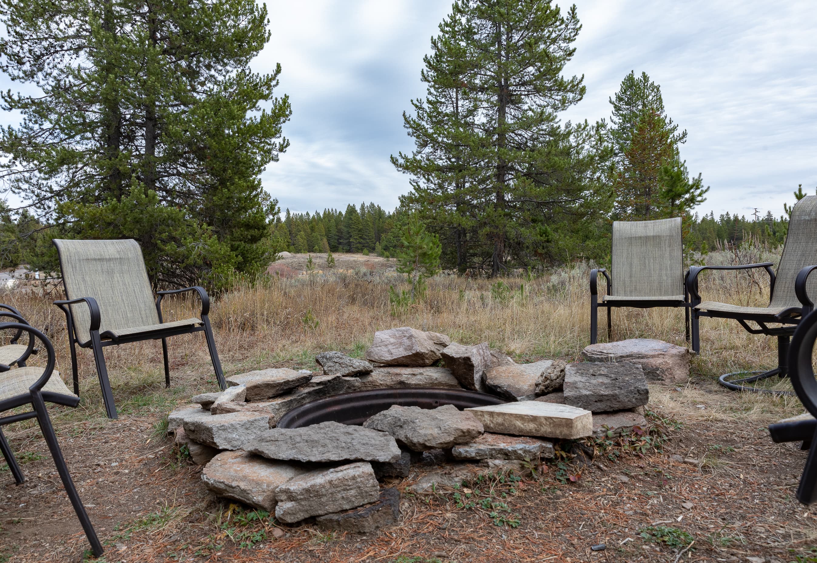 Fire pit with seating and river view (wood not provided).