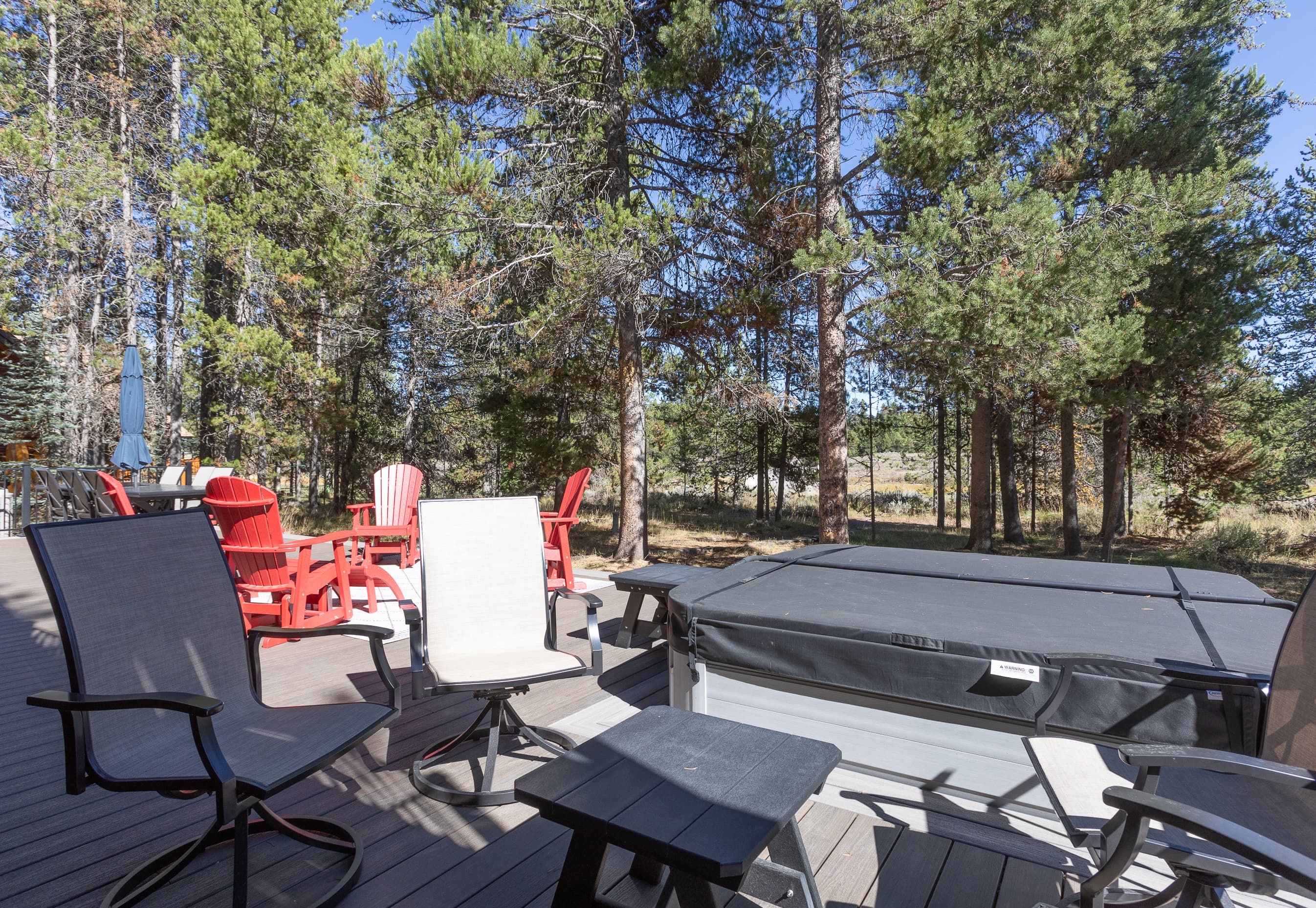 Patio chairs and side tables make a cozy place for conversation or for taking dips in the hot tub.