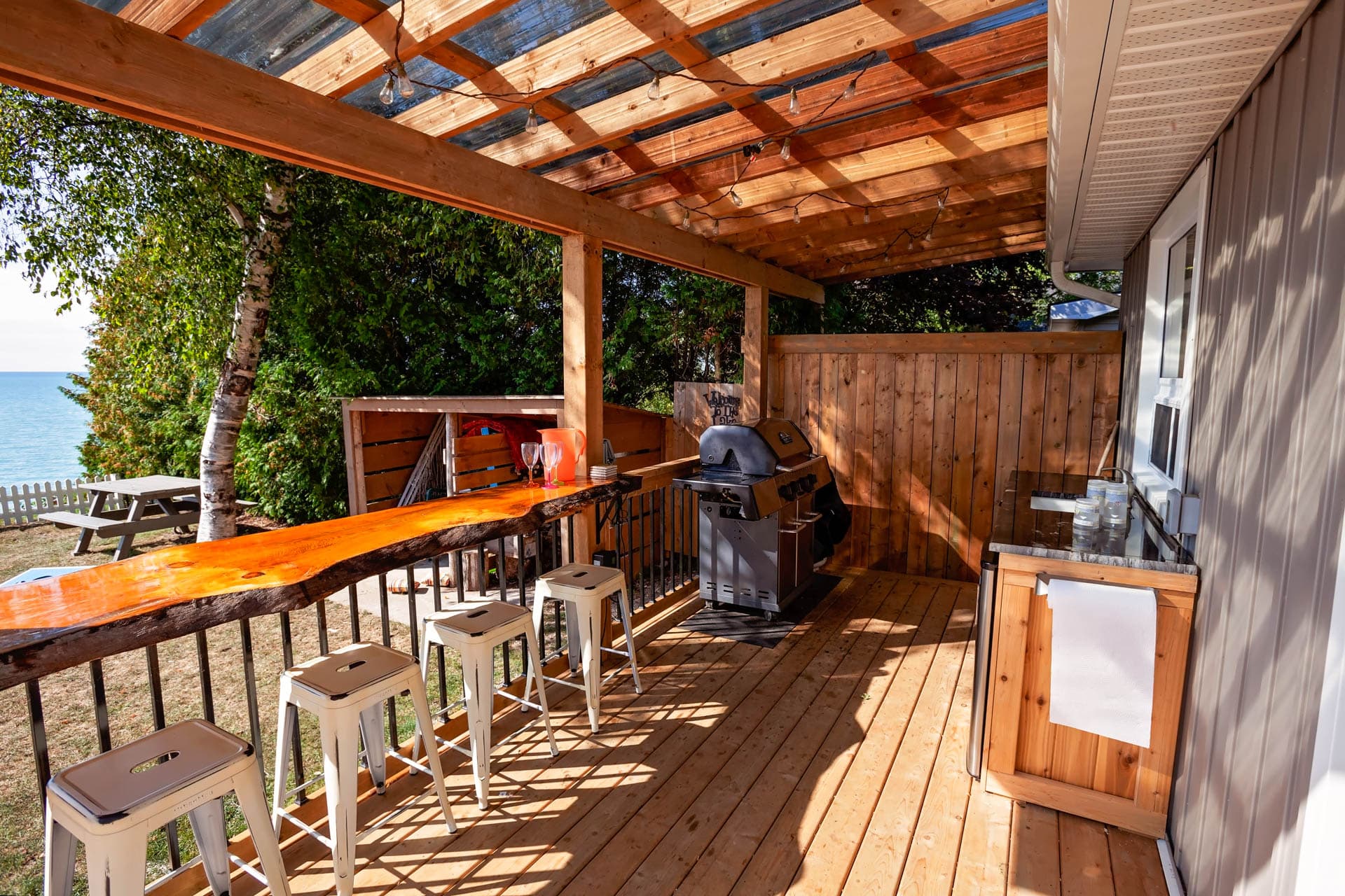 Outdoor kitchen with beverage fridge, sink and BBQ