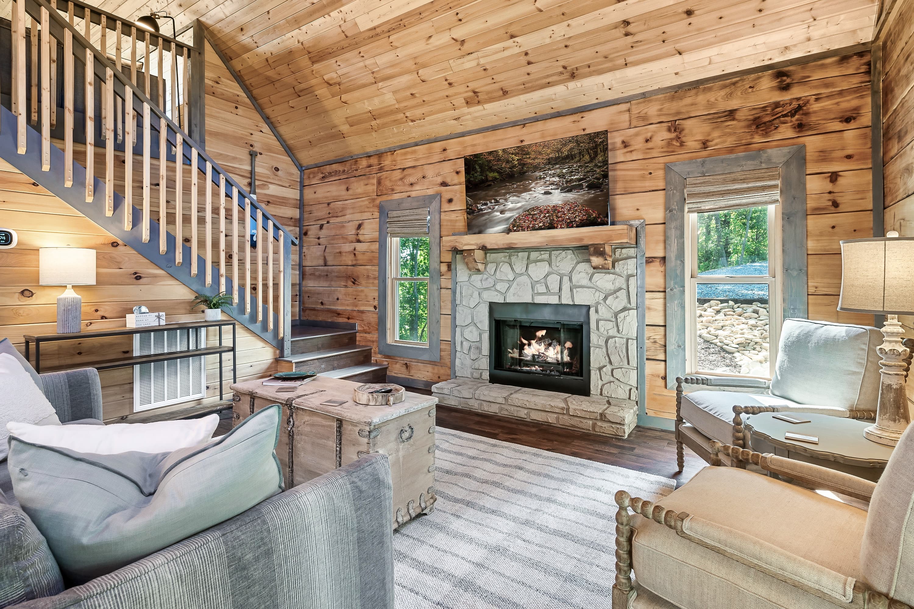 Stone fireplace and soaring ceilings for cozy Douglas Lake evenings