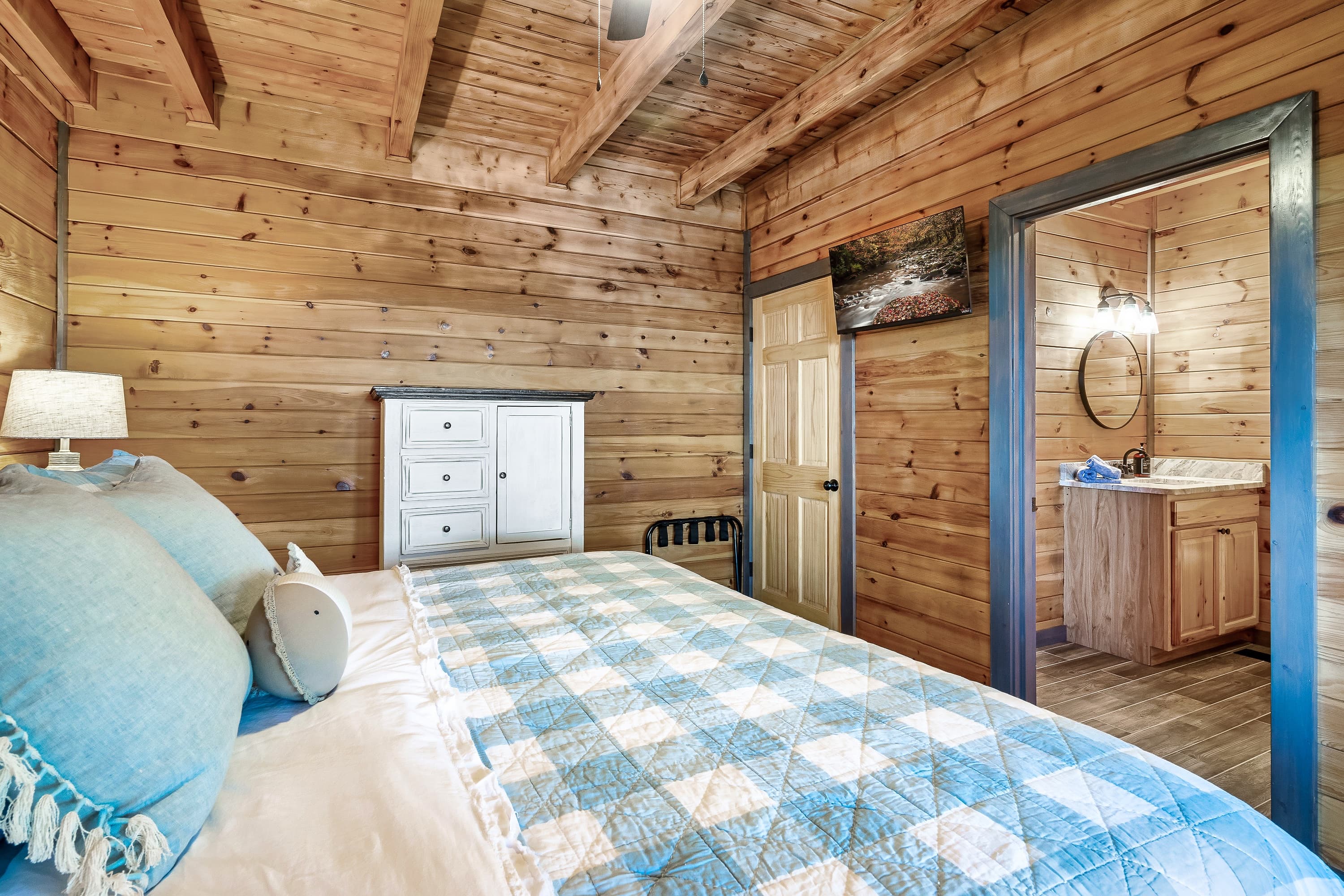 Spacious master bedroom with king bed and panoramic lake views