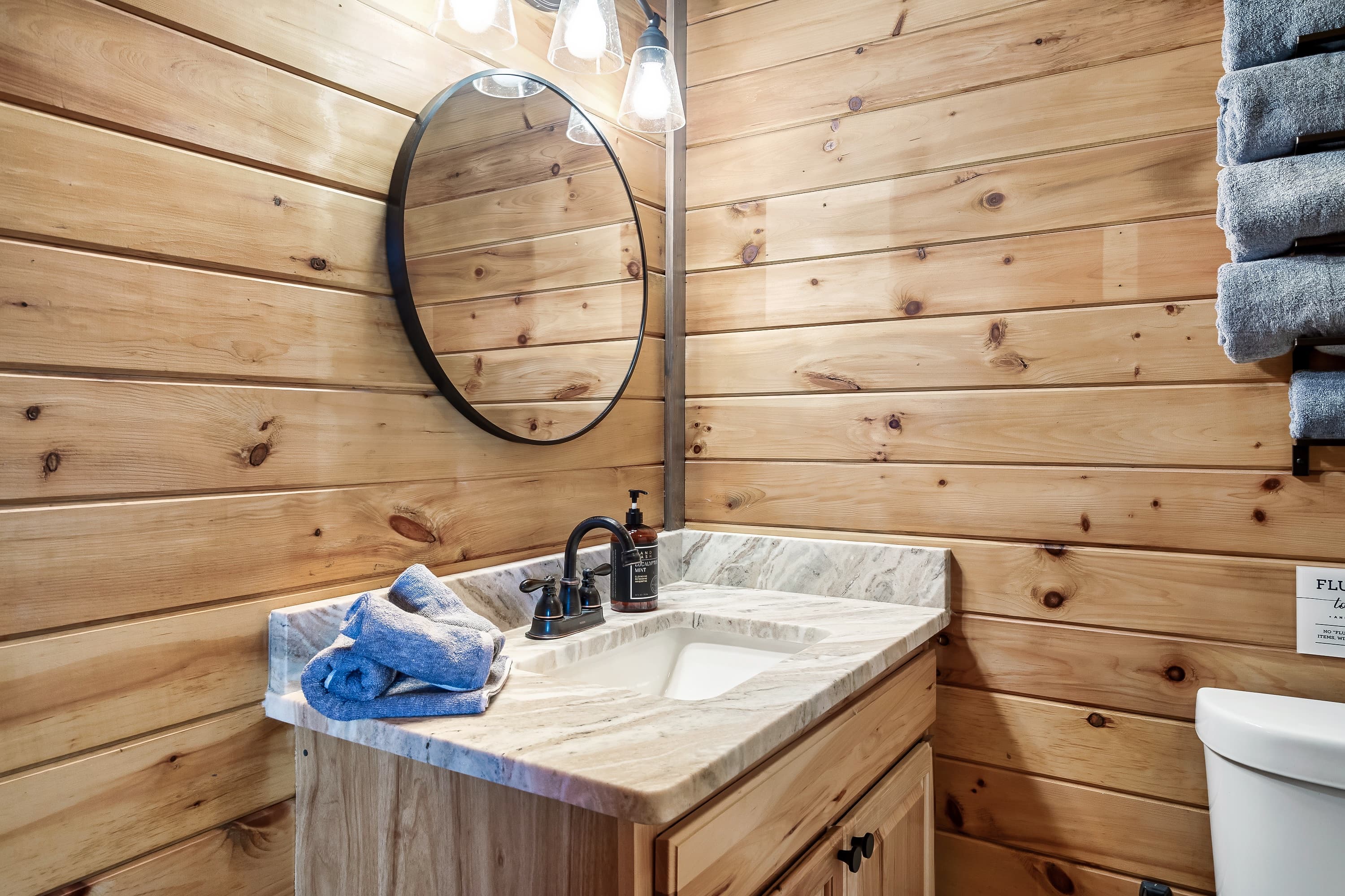 Updated bath with marble vanity serving the lake view bedroom