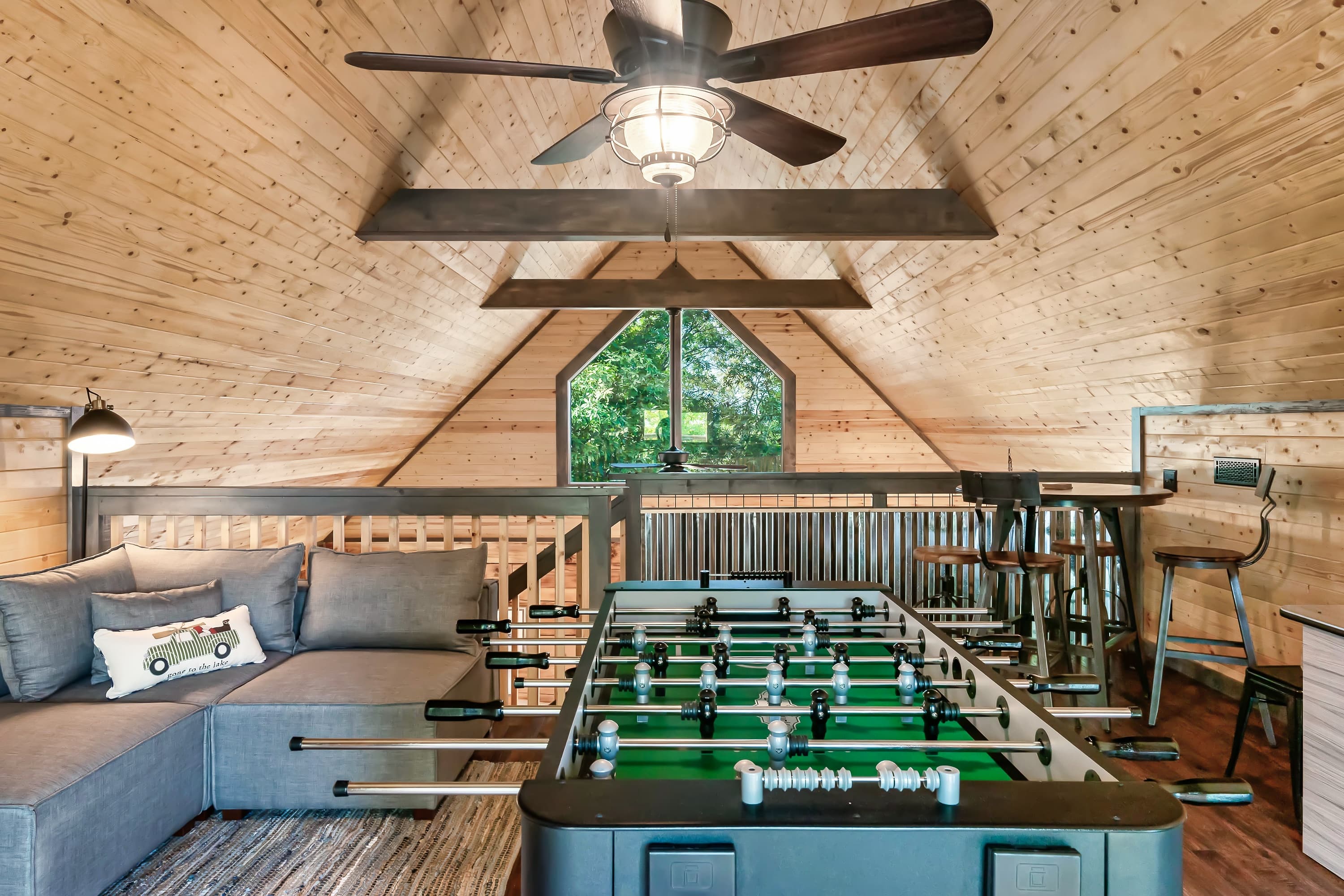 Loft game room with foosball, arcade, and Douglas Lake views