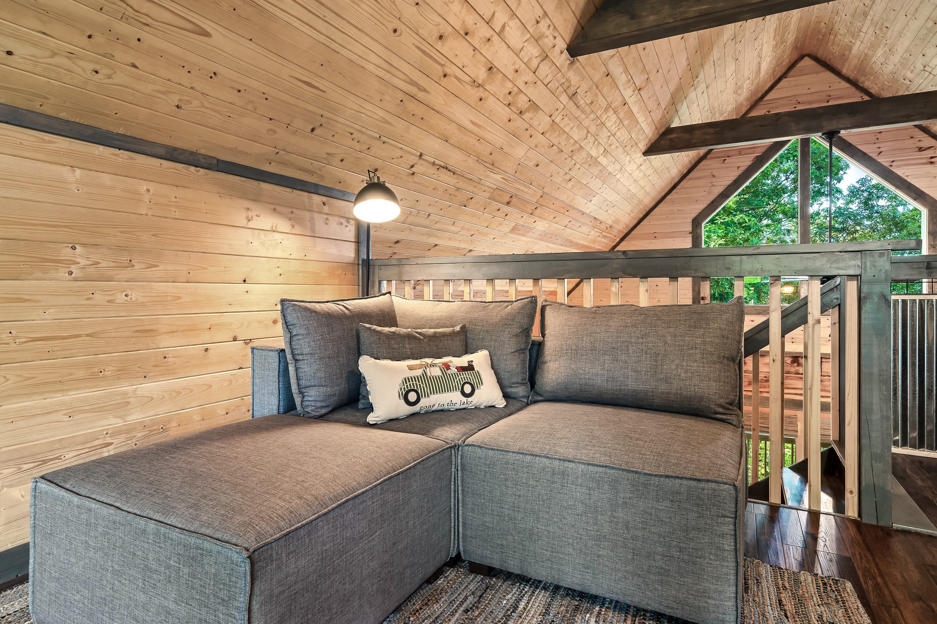 Cozy loft nook with treetop views through the double doors window