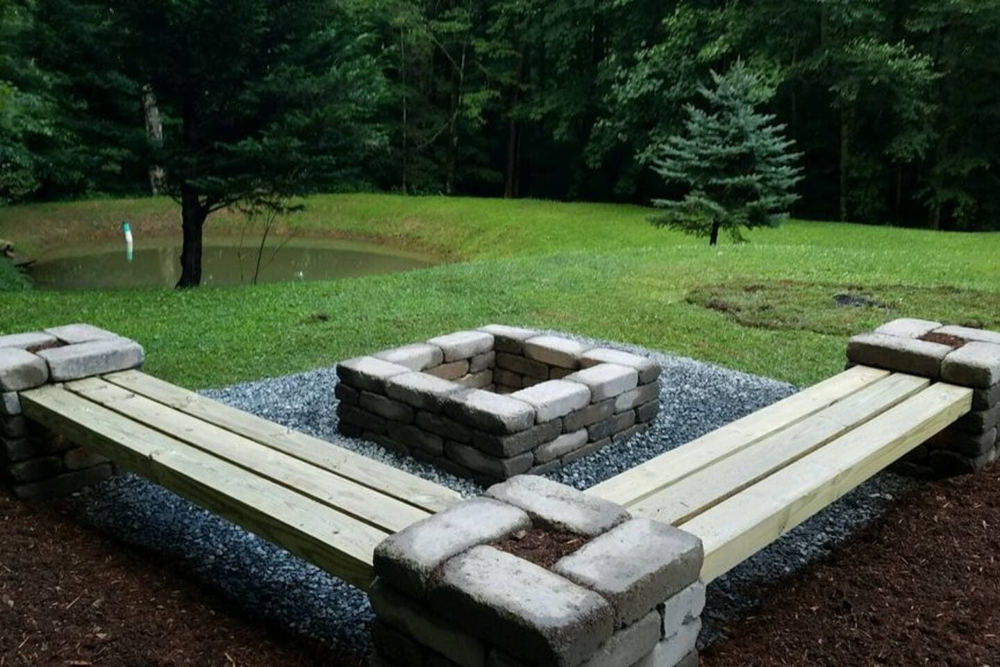 fire pit overlooking pond on property