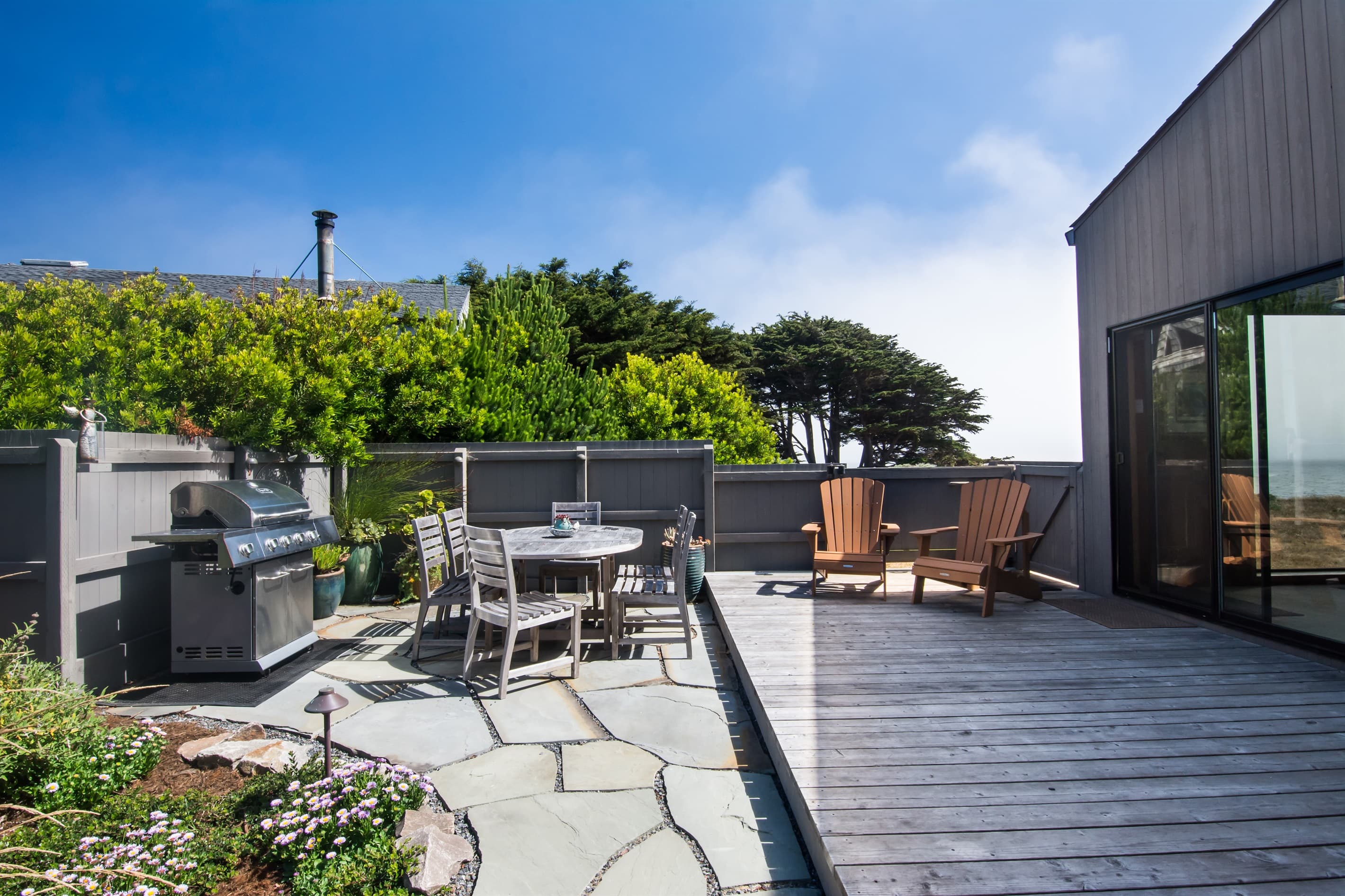 "We also loved spending time in the spacious outdoor area, all enclosed so that our 2 year old grandson could run around safely." 
Includes: Gas BBQ, out door eating, direct access to bluff, hot tub, lounge furniture.