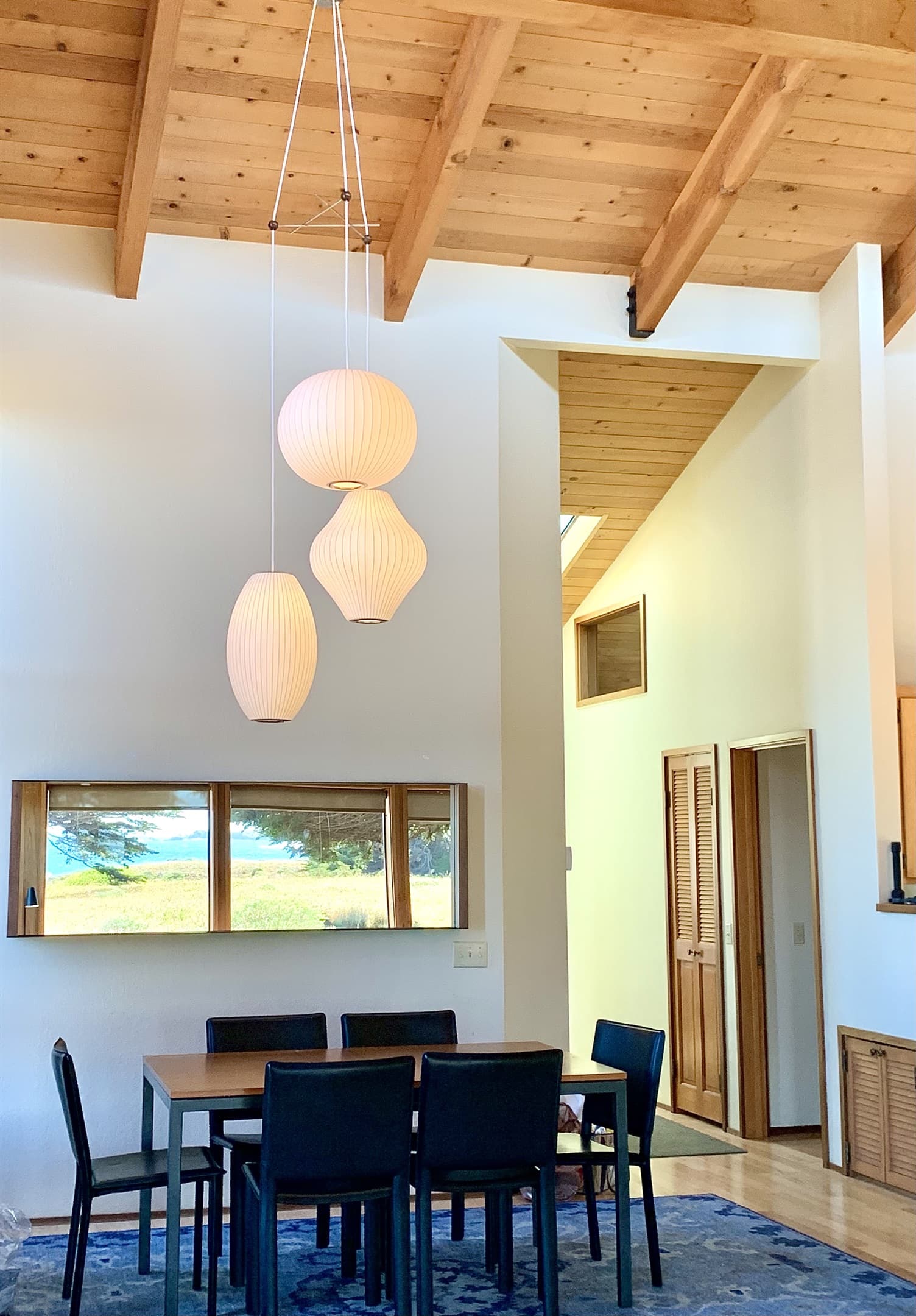 Elegant dining beneath sculptural pendant lighting, with vaulted ceilings and coastal-inspired design—where ocean views surround you from every seat, blending beauty and tranquility with every meal. 