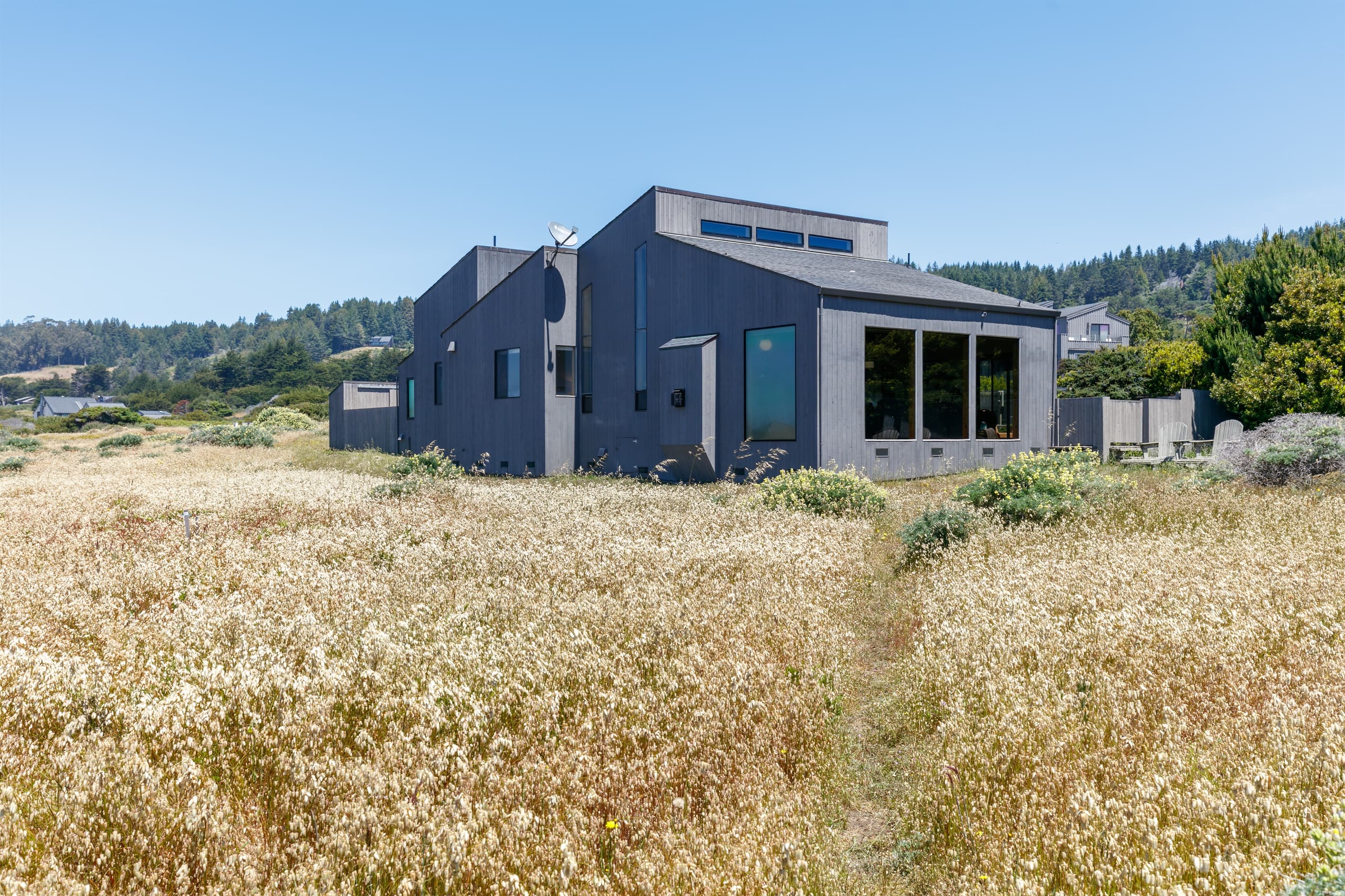 Exterior as viewed from ocean bluff trail. Note new house is under construction on the left side of Abalone Bay