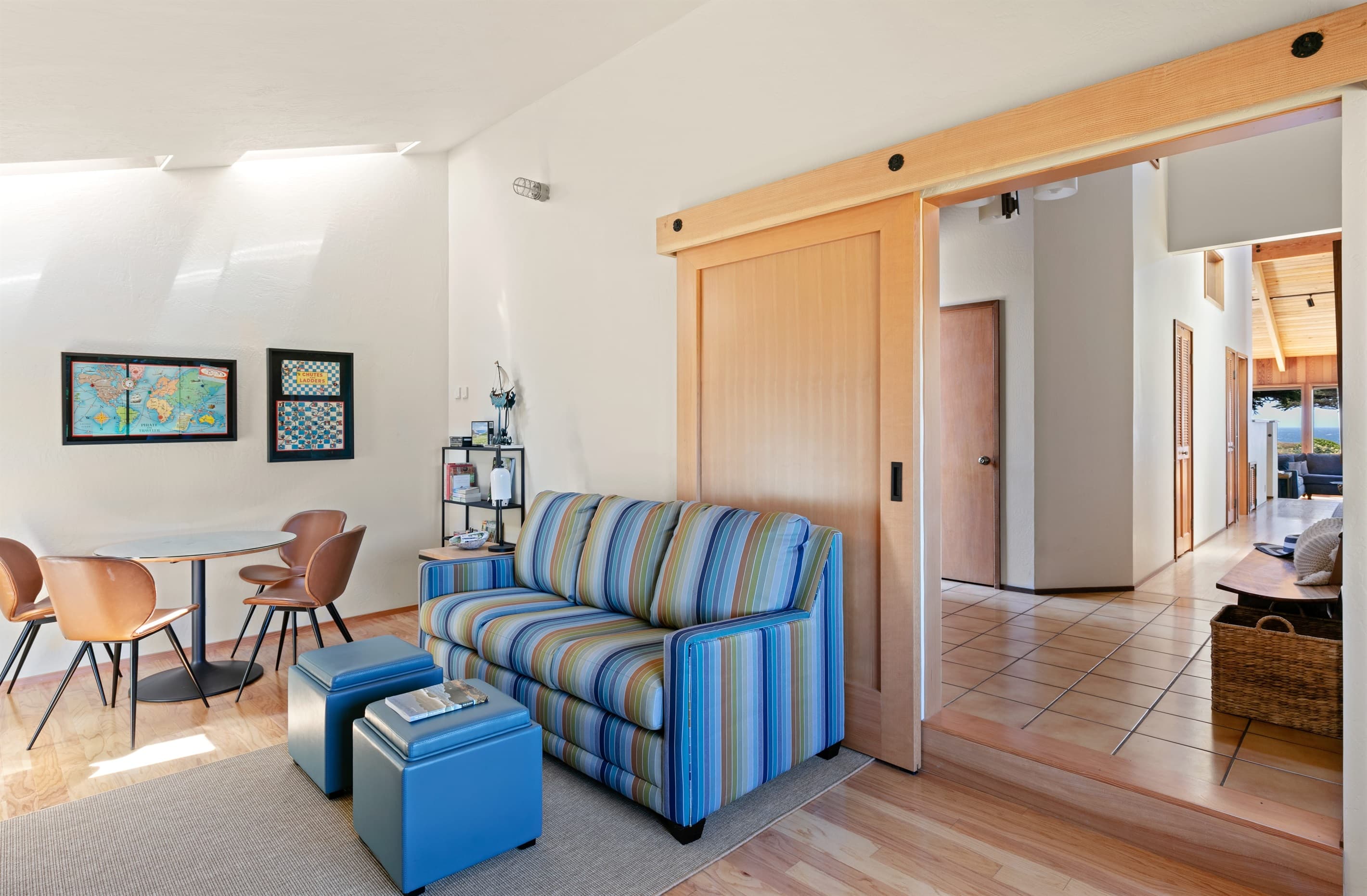 This versatile coastal haven with a sliding door doubles as an office with fast WiFi and privacy, then transforms into a family game room with puzzles, books. Sofa sleeper is an add-on amenity.