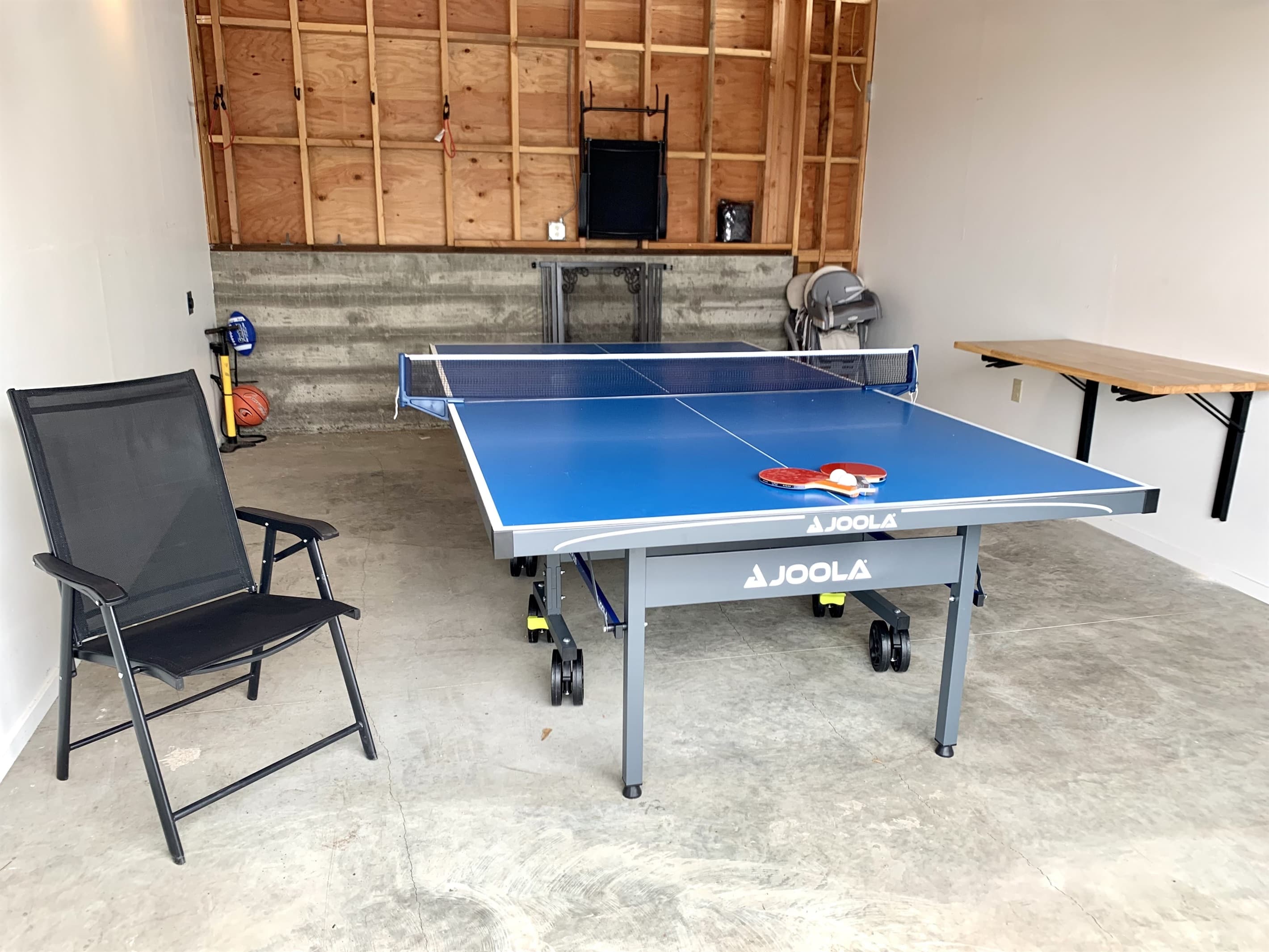 Store your car or use the garage as a game space with ping pong and a wall table. Stocked with lounge chairs, yoga mats, sports gear, yard games, and family essentials, from a highchair to a dog gate.