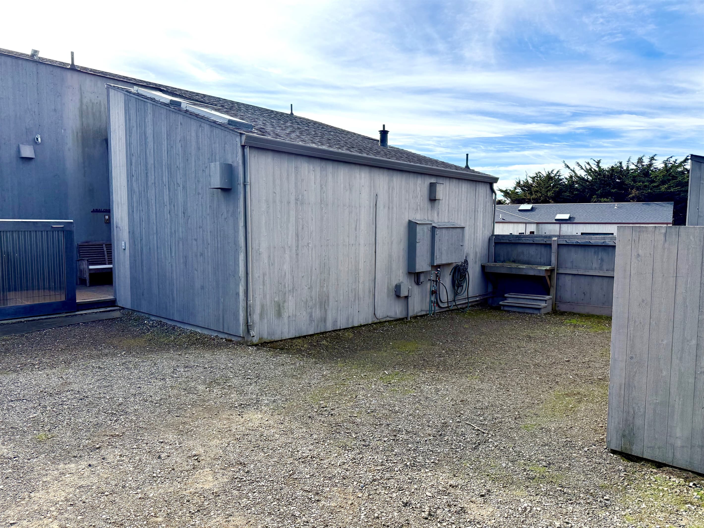 Parking space located between house and garbage shed. Fish cleaning station at the fence.