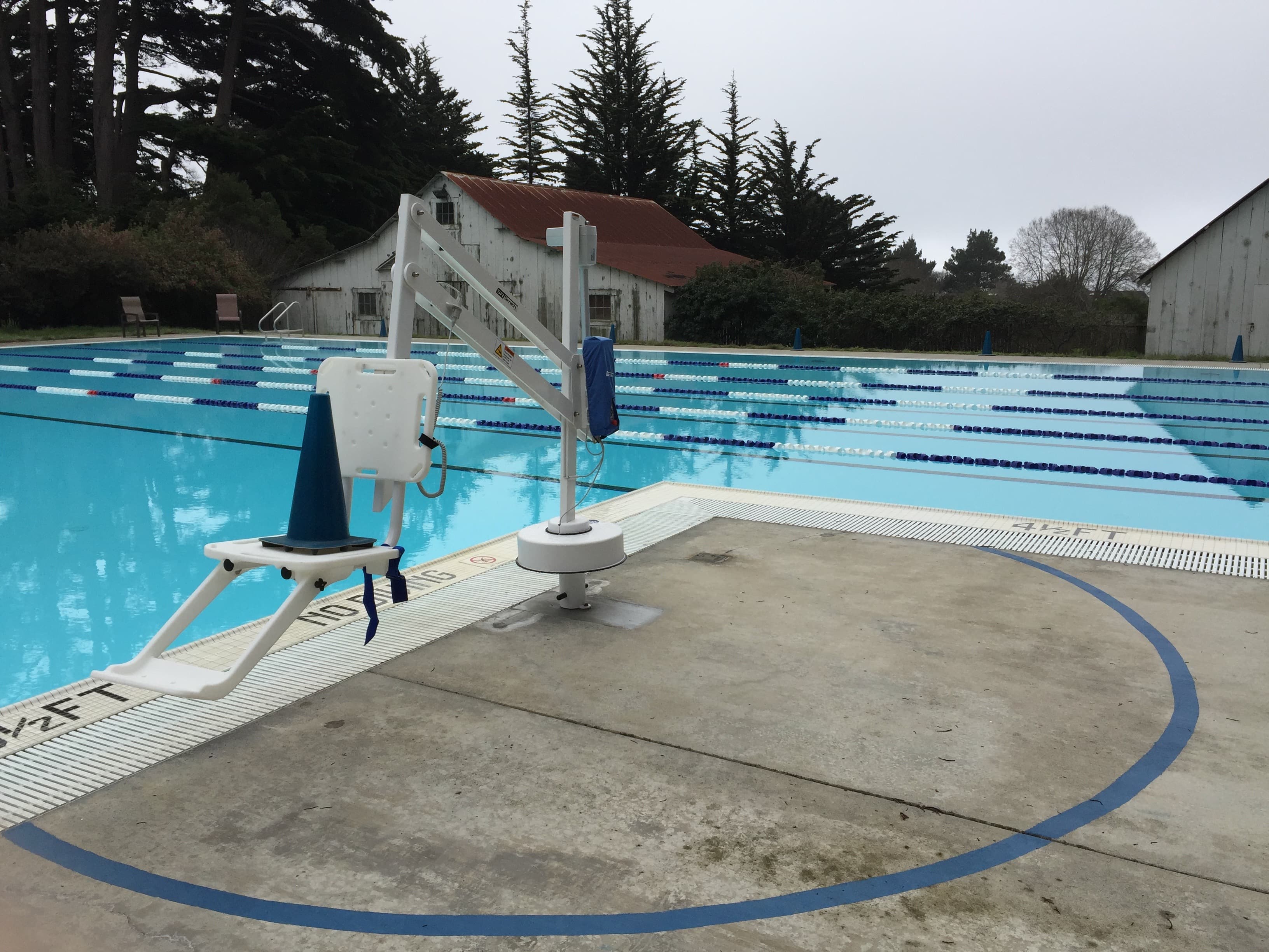 Del Mar Recreation Center Pool lift, aquatic lift, pool hoist, designed for accessibility, features a seat to lower people with mobility issues into the water