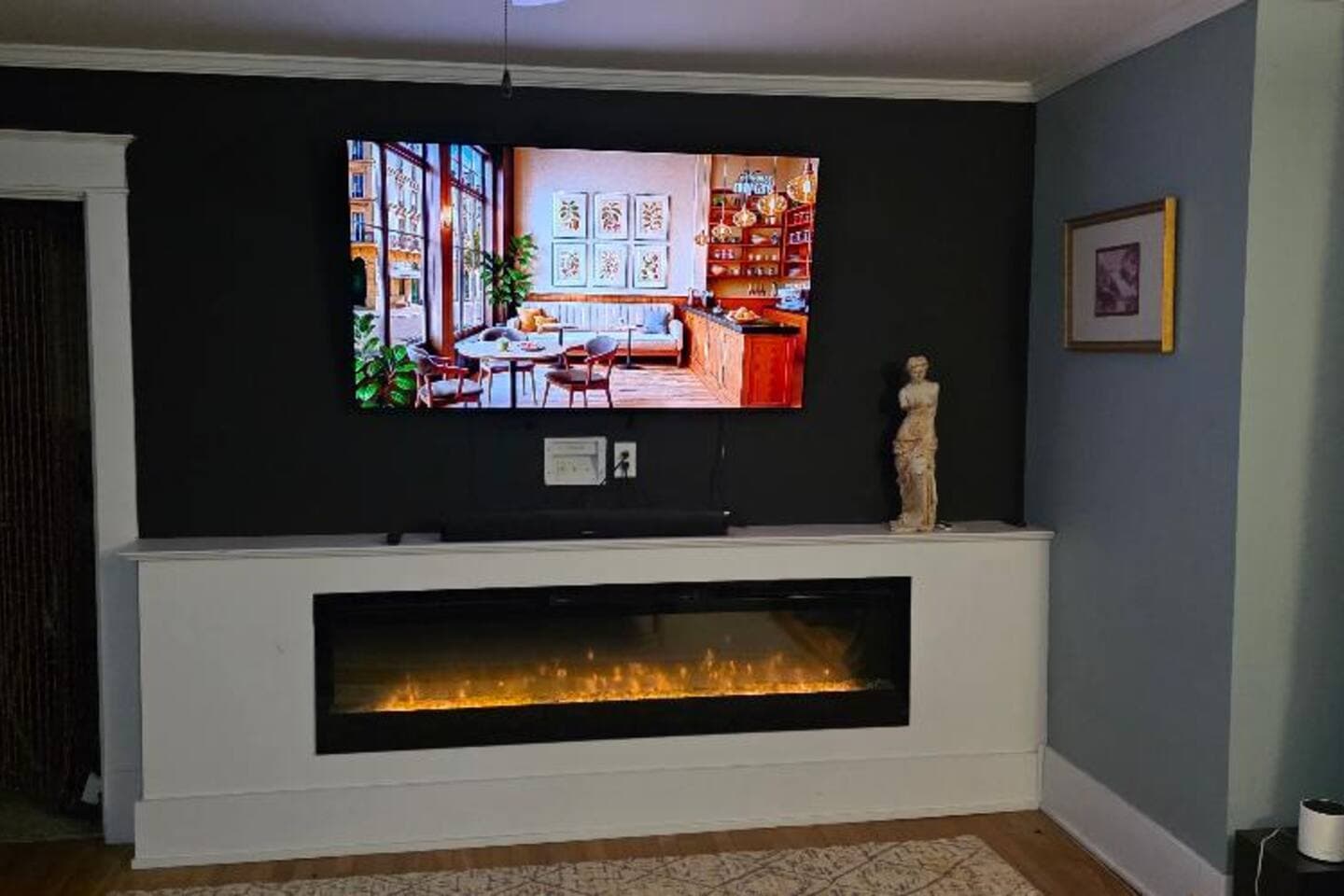 The main bedroom features a 65" smart TV, an electric fireplace, and a cozy King-sized bed.  You will love this cozy spot!