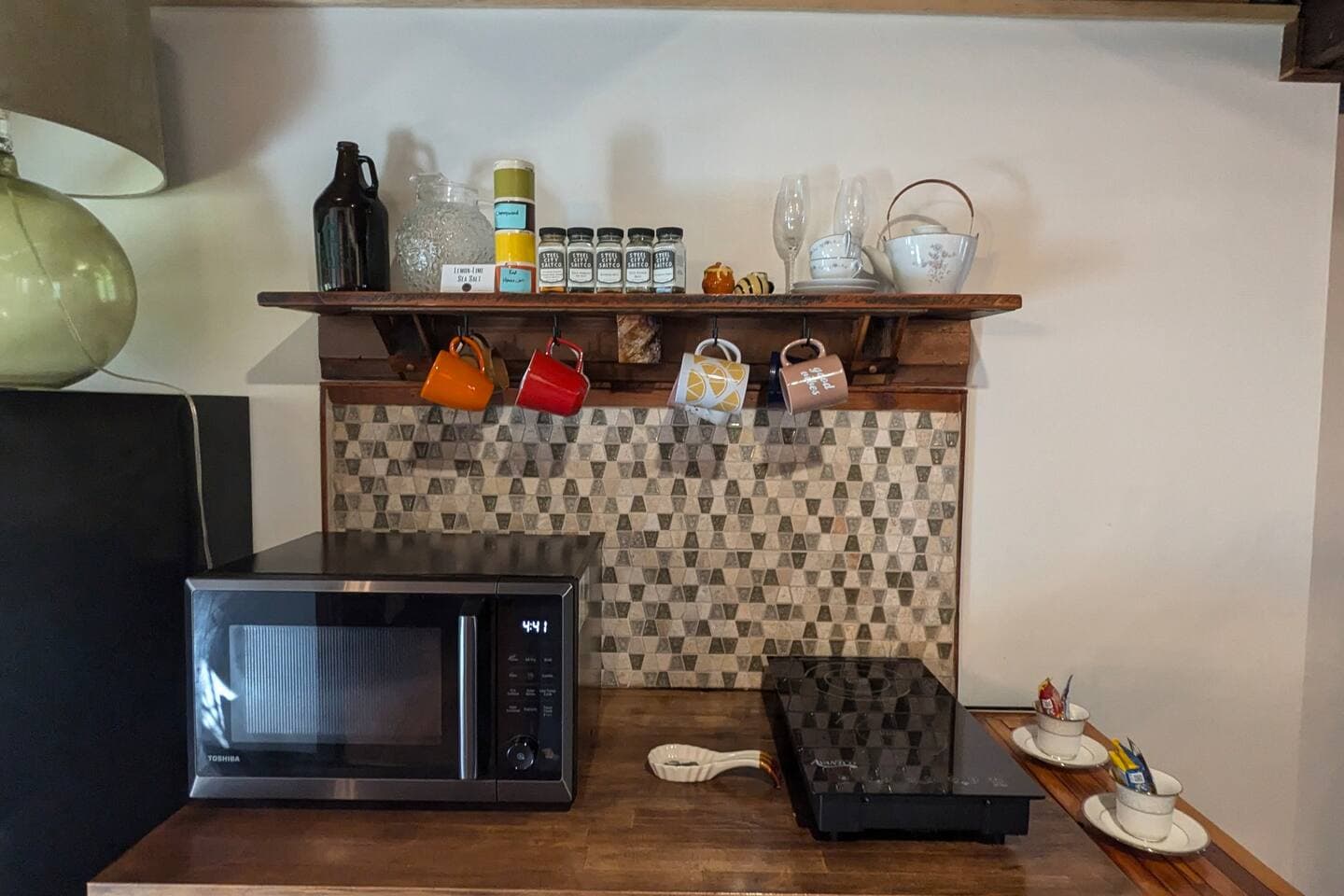 Stocked kitchenette with kinetic stove and a microwave / oven / air fryer