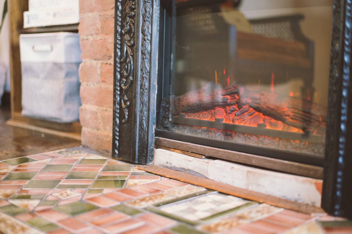 Gather around the cozy electric fireplace and admire the upcycled historic hearth