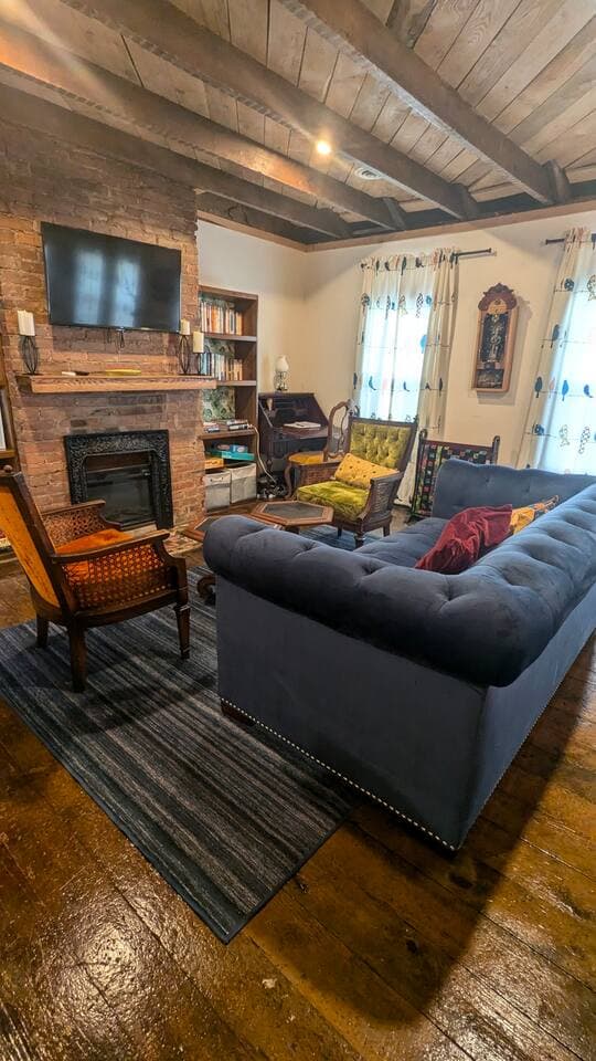Bright, comfortable living room with a streaming TV, fireplace, desk, music, books and games