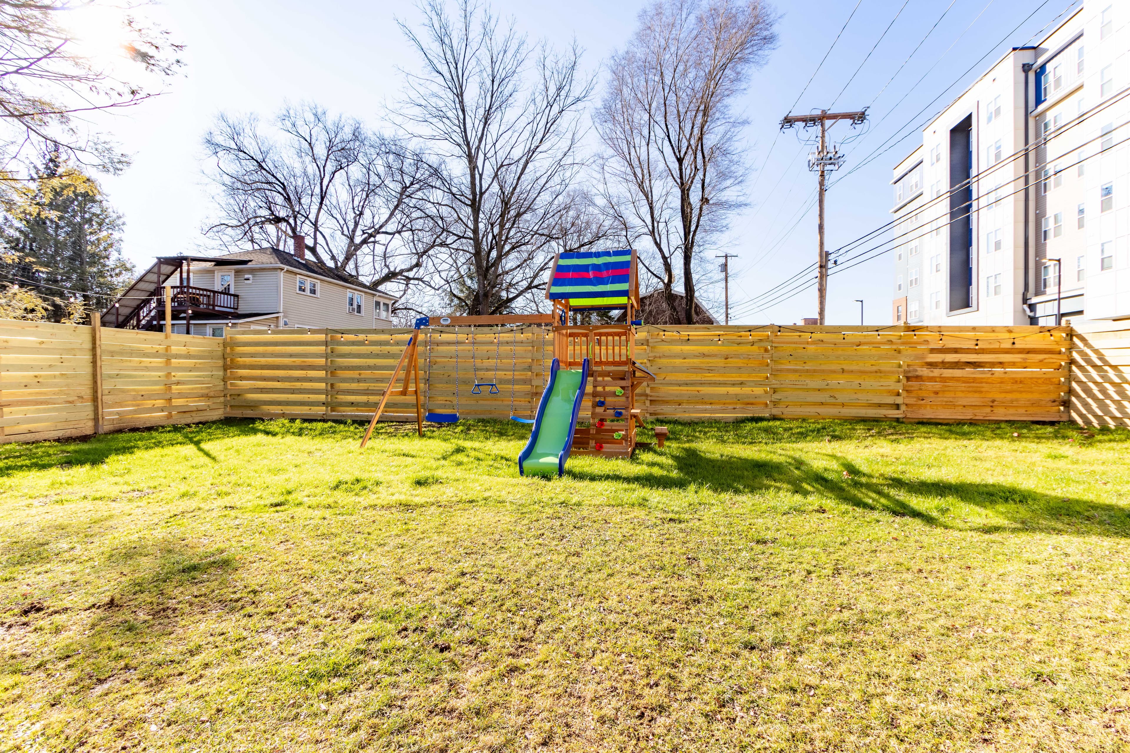 Fenced in backyard with new playset