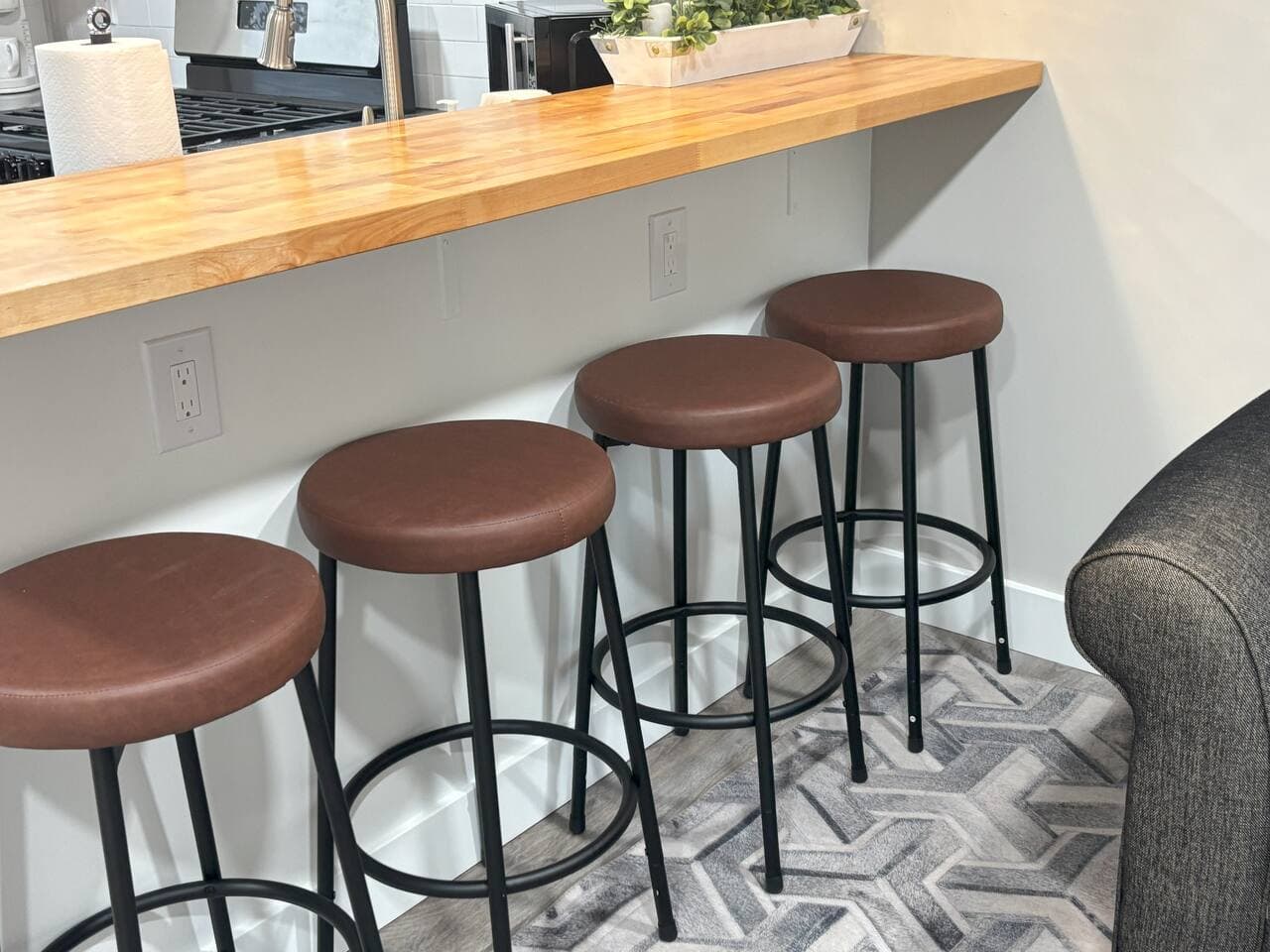 The fully stocked kitchen flows into the living area, and is separated by a seating bar and stools where you and your family and friends can enjoy the lovely meals you prepare together.  