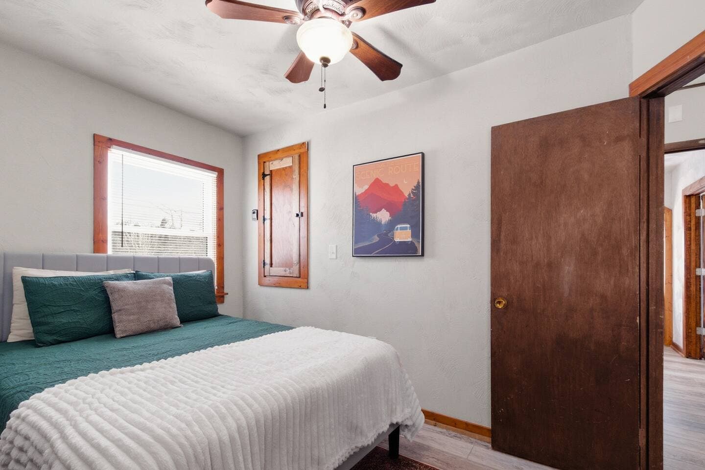 the cozy second bedroom features a comfortable queen sized bed. 