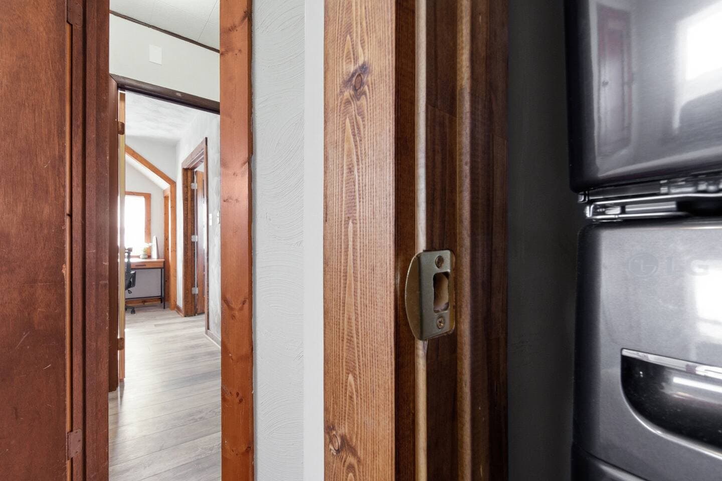 The modern stackable washer and dryer are conveniently located on the second floor for easy laundry. 