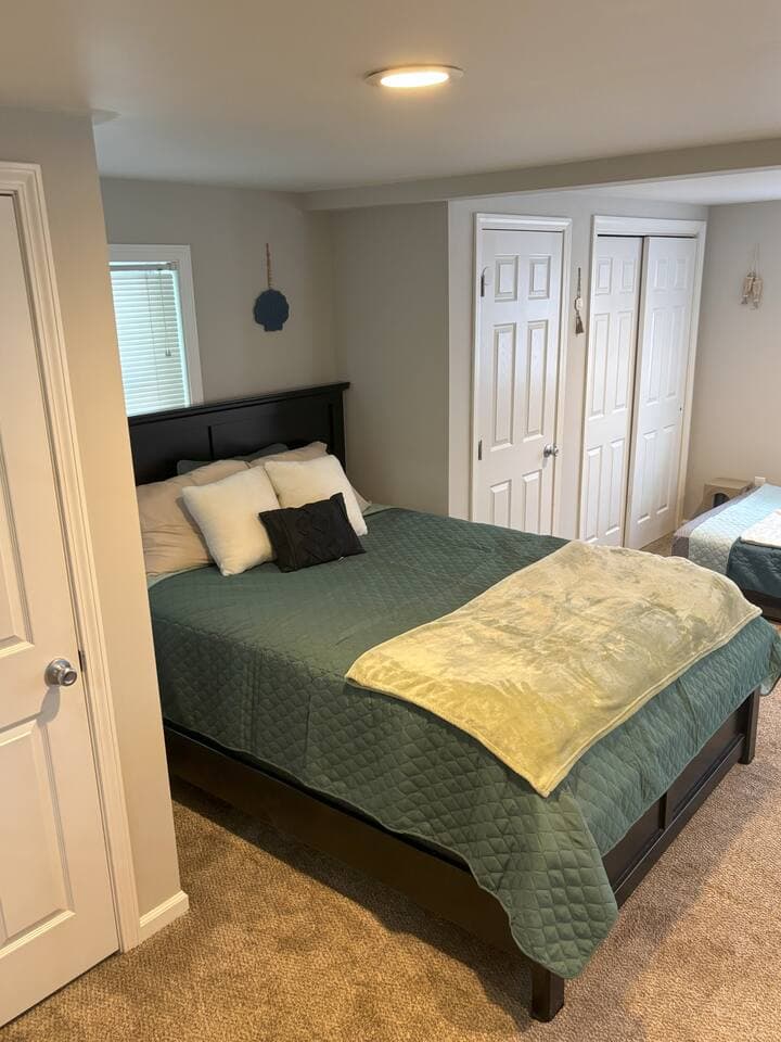 This comfortable bedroom features both a queen bed and a full bed, providing flexible sleeping arrangements for families, friends, or groups. Fresh linens and cozy bedding are provided to ensure a restful night’s sleep.
